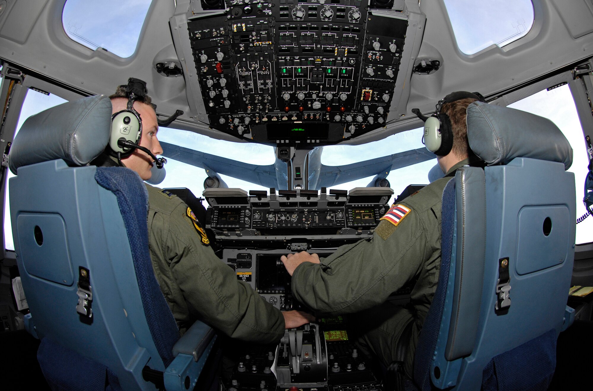 Capt. John Tucker and Maj. Anthony Davis, both assigned to the Hawaii Air National Guard's 204th Airlift Squadron at Hickam Air Force Base, Hawaii, take fuel for their C-17 Globemaster III from a KC-135 from the 909th Air Refueling Squadron from Kadena Air Base, Japan, while en route to China May 17, 2008. A U.S. Pacific Command mission employed one C-17 from the 15th Airlift Wing at Hickam and another from the 3rd Wing at Elmendorf Air Force Base, Alaska, to deliver nearly 200,000 pounds of cargo in the wake of a devastating earthquake. (US Air Force photo/Tech. Sgt. Chris Vadnais)