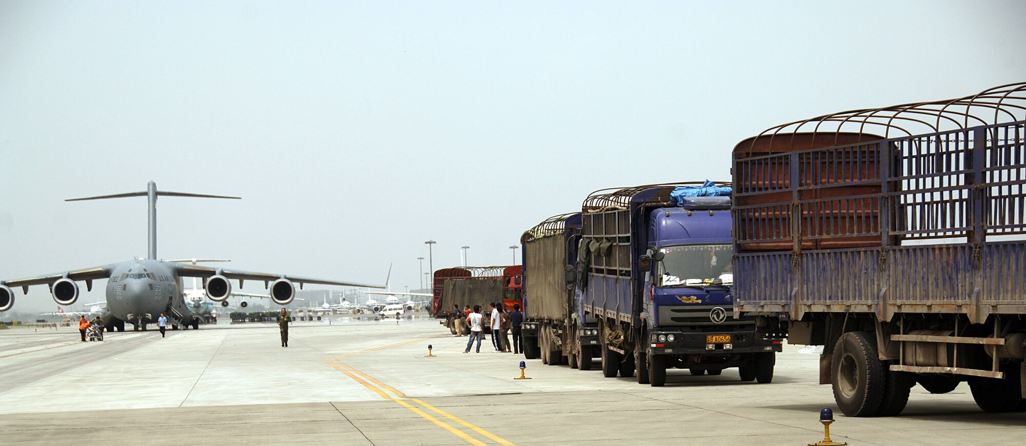 Several personnel from various organizations helped move and palletize five truck loads of FEMA supplies for relief efforts in China. The 18 pallets of supplies, which included lanterns, tents, chain saws and generators were unloaded from an United States Air Force C-17 aircraft and loaded into Chinese trucks. The supplies are to be delivered to the victims of the earthquake in Sichuan, China. (U.S. Air Force photo by Senior Airman Steven Donatelli)
