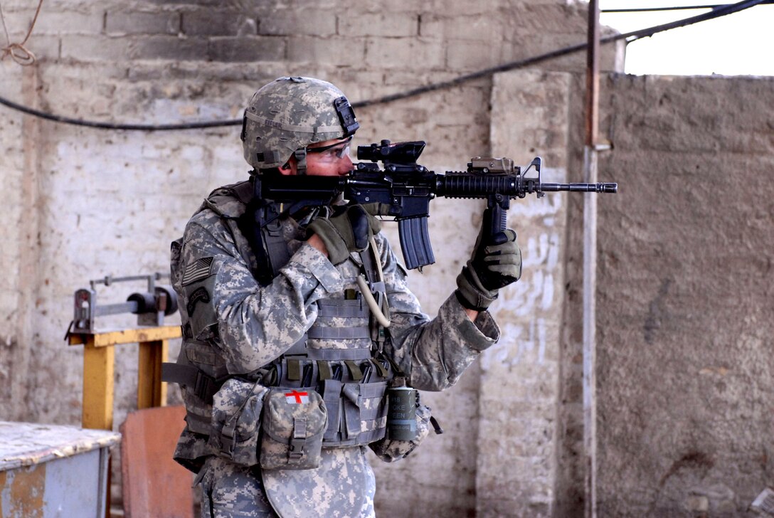 U.S. Army Pfc. Robert Cooper looks for suspicious activity during a mission in the Thawra 2 neighborhood of the Sadr City district of Baghdad, May 11, 2008. Cooper is is assigned to the 1st Armored Division's Headquarters and Headquarters Company, Task Force 1st Battalion, 6th Infantry Regiment, 2nd Brigade Combat Team, which is attached to the the 3rd Brigade Combat Team, 4th Infantry Division, Multi-National Division – Baghdad.