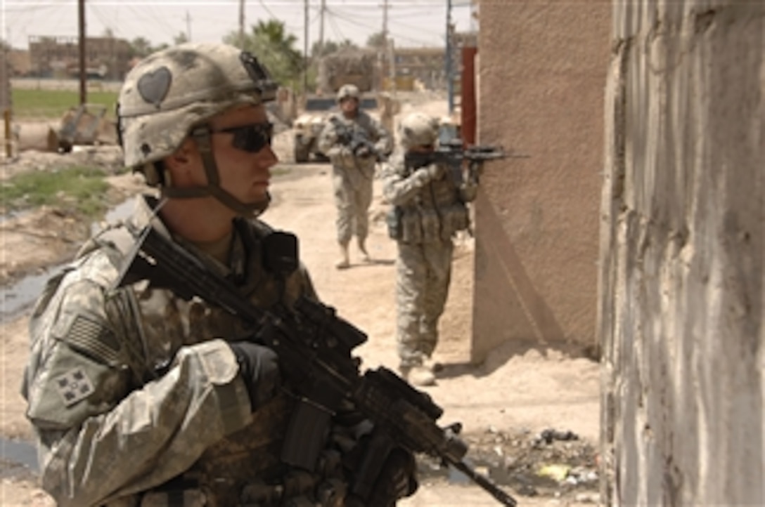 U.S. Army soldiers keep watch down an alley while providing security near Checkpoint 9 in northern Gazaliyah, Iraq, on May 15, 2008.  The soldiers are from Bravo Troop, 1st Squadron, 75th Cavalry Regiment, 2nd Brigade Combat Team, 101st Airborne Division.  