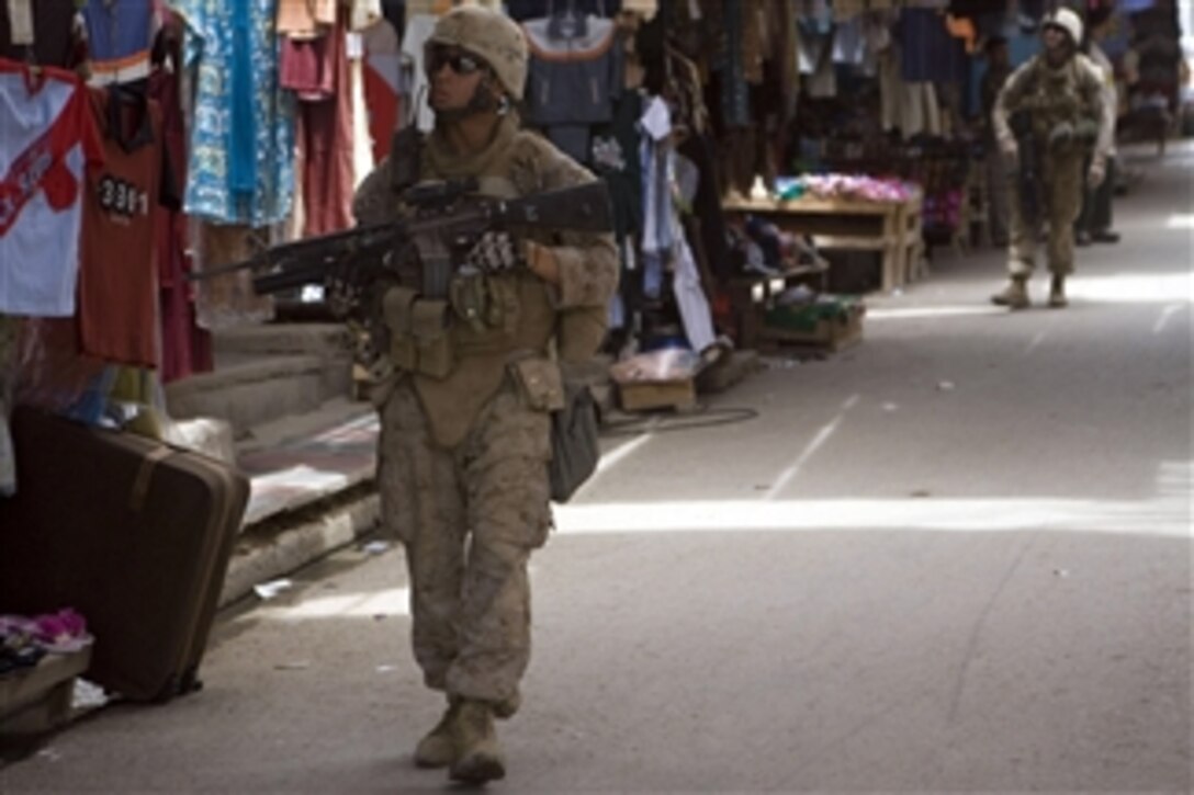 U.S. Marine Corps Lance Cpl. Israel Aguirre (left) and Lance Cpl. Austin D. Breedlove from India Company, 3rd Battalion, 4th Marine Regiment, Regimental Combat Team 5 patrol through a marketplace in Hit, Iraq, on May 14, 2008.  The Marines are conducting patrols in order to gain atmospherics on the local population and to ensure their well-being.  