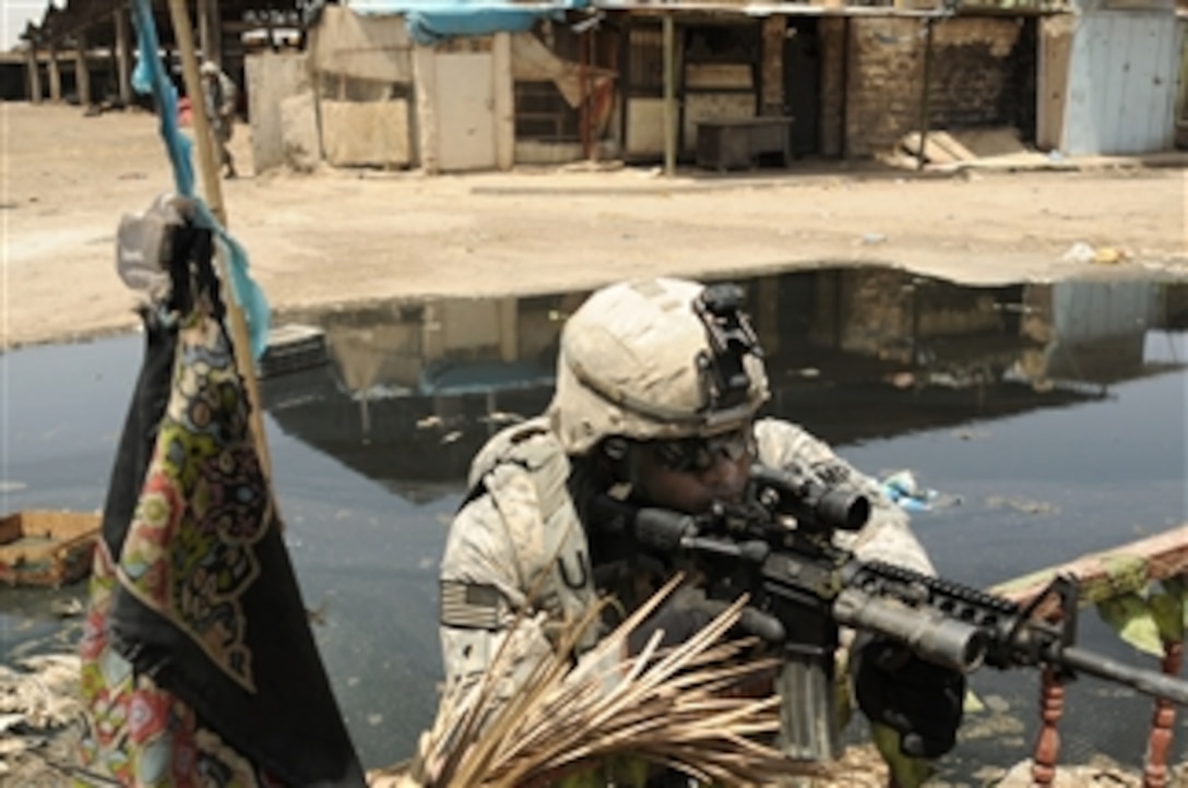 U.S. Army Spc. Marcus Wright from 3rd Brigade Special Troops Battalion maintains a fighting position during operations in Jamilla Market in the Sadr City district of Baghdad, Iraq, on May 15, 2008.  