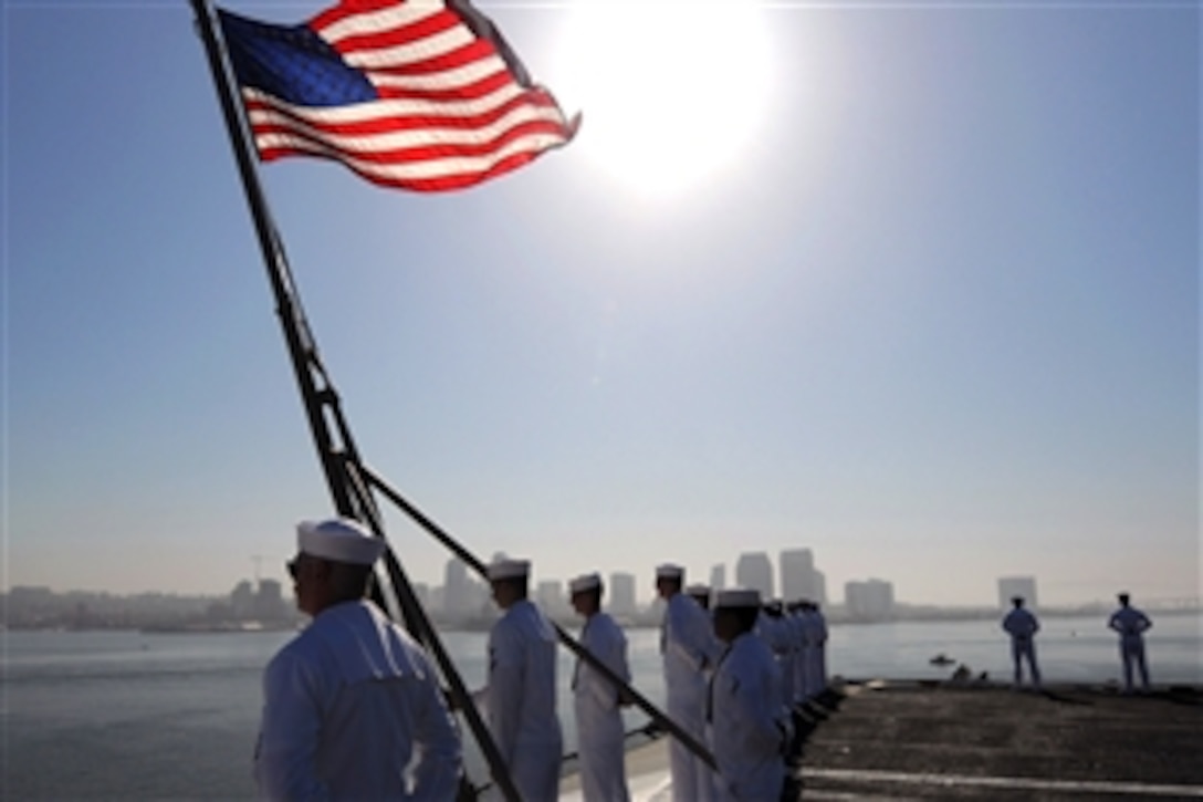 U.S. Navy sailors man the rails and prepare to shift colors signaling that the aircraft carrier USS Ronald Reagan is underway, San Diego, Calif., May 19, 2008. 