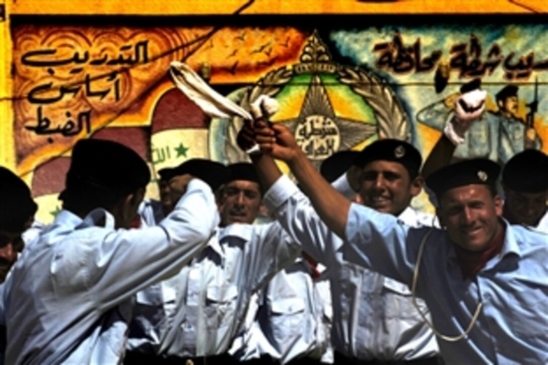 Kirkuk Provincial Police Academy Cadets rejoice in their graduation with dance and cheers, May 15, 2008. The four hundred graduates are the first former Sons of Iraq to transition into the Iraqi Security Forces within the Kirkuk Province.