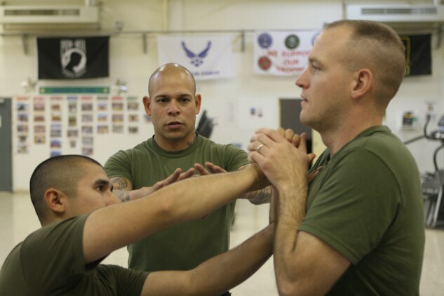 Adrian Figueroa, a corpsman with 2nd Battalion, 2nd Marine Regiment, Regimental Combat Team 5, instructs Marines during a greenbelt course at Al Qaâ??im, Iraq, May 20.  Despite growing up in a world of drugs and violence, Figueroa has excelled at being a corpsman and has been meritoriously promoted twice.