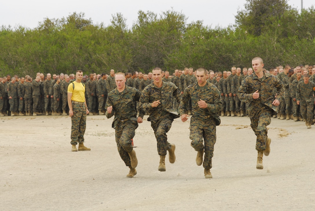 The first four Company G recruits sprint to the beginning of the Depot Combat Conditioning Course Evaluation Course. The CCE is a modified version of the obstacle with additional tasks.