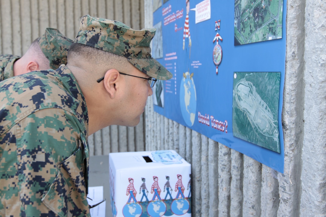 Gunnery Sgt. Joseph Herrera, geographic intelligence specialist, 1st Intelligence Battalion, I Marine Expeditionary Force, Camp Pendleton, examines a map produced by the base’s Geospatial Information Systems at the Bldg. 1160, Nov. 18. The map was on display as part of the base’s third annual GIS Day event.
