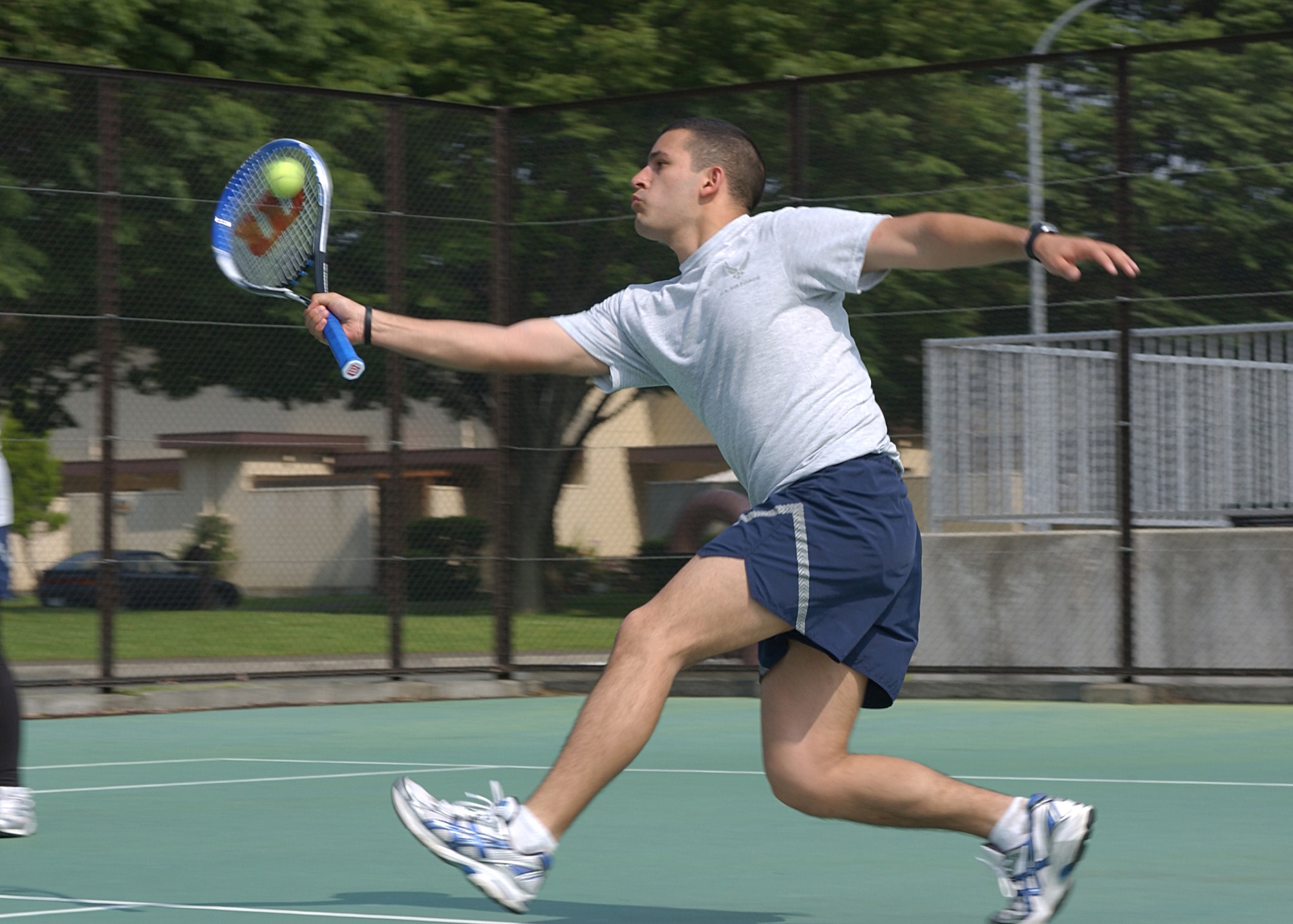 YOKOTA AIR BASE, Japan - Airman 1st Class Raymond Salazar, from the 374th Communications Squadron, hits a tennis ball during a tennis match on Yokota'a 2008 Safety and Sports Day on May 22. Sports Day gives squadrons a chance to relax and compete in a number of sports such as dodgeball, softball and volleyball. (U.S. Air Force photo by Airman 1st Class Jonathan Fowler)                           