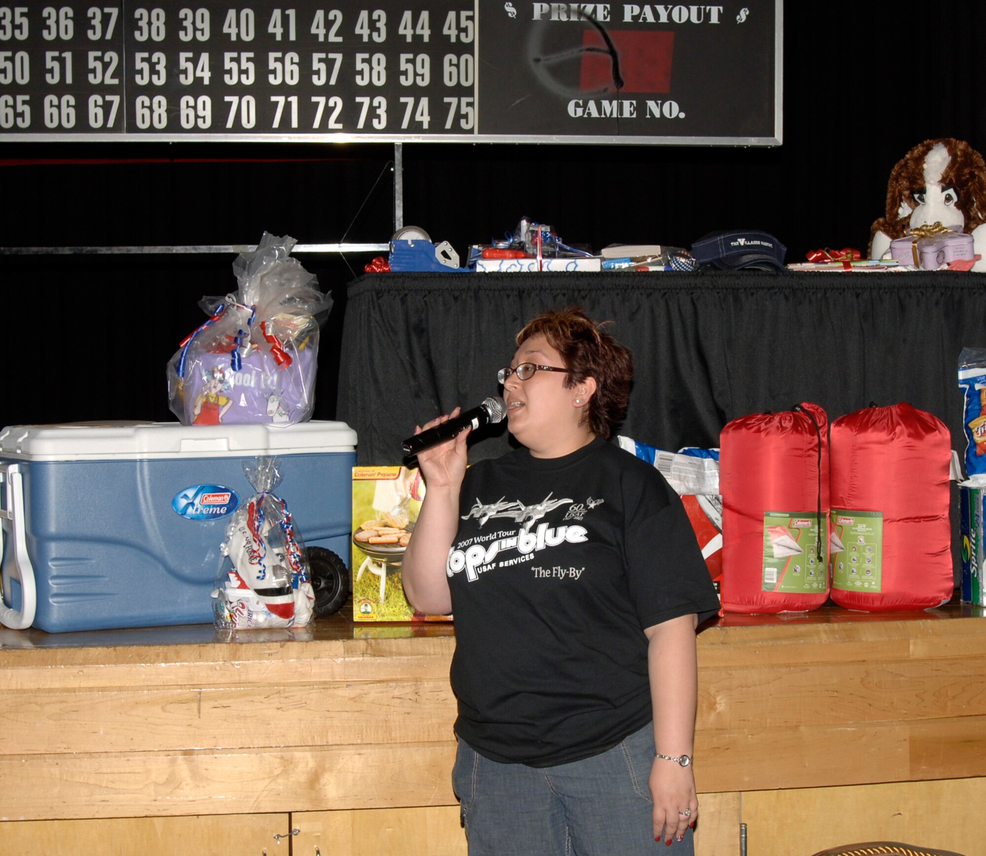 MCCONNELL AIR FORCE BASE, Kan. -- Fe Vorderlandwehr, 22nd Services Squadron, makes announcements regarding Family Fun Night at the Robert J. Dole Community Center, May 16. Ms. Vorderlandwehr help set up the event’s activities, including gathering prizes to award out for family bingo. (Photo by Senior Airman Laura Suttles) 