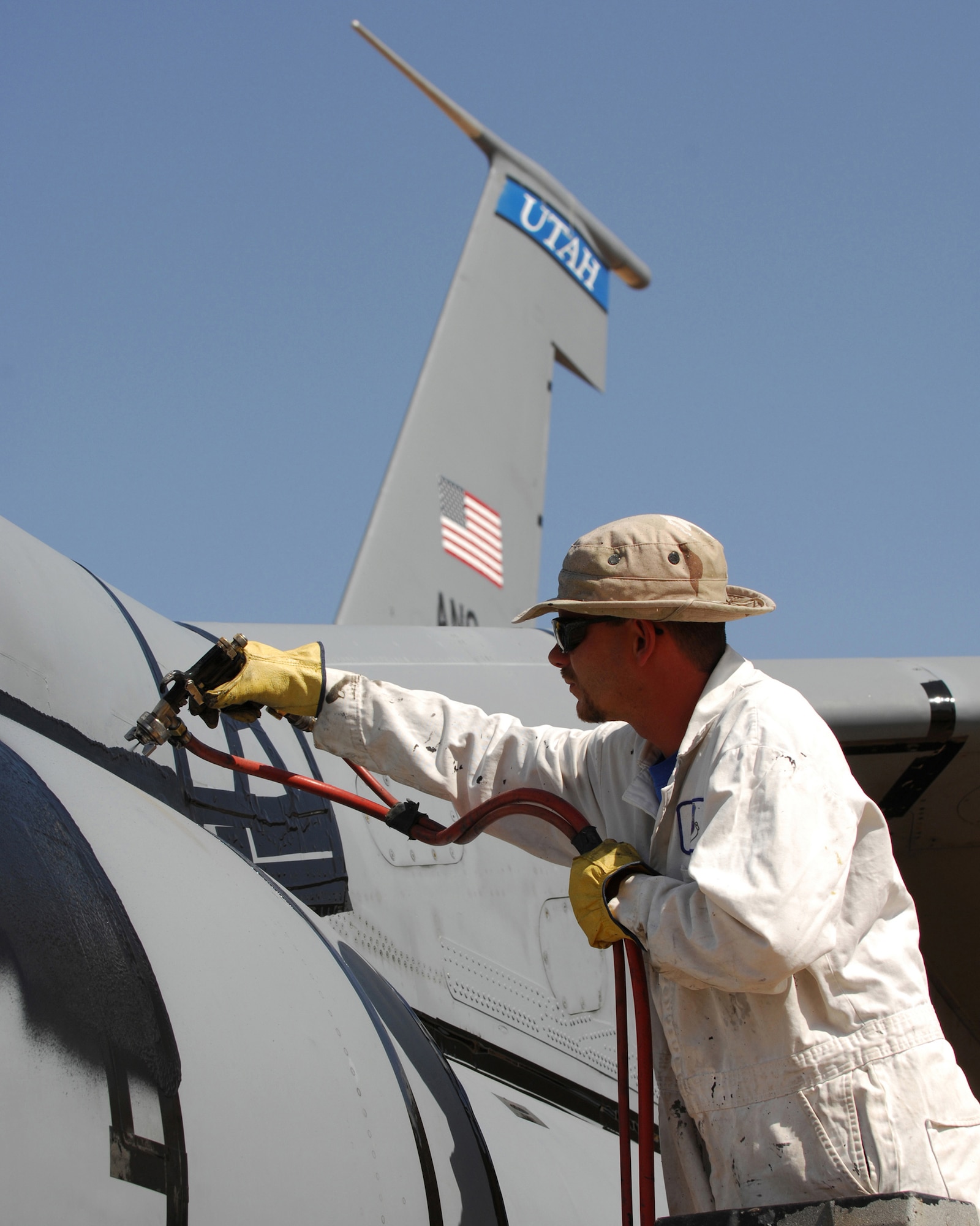 Sam Wilkins, a spray-lat technician with the 578th Storage and Disposal Squadron at Davis Monthan Air Force Base, prepares an Air Force KC-135 E-model aircraft for preservation and storage. The 50-year-old aircraft was delivered to the group for long-term storage at the 2,600 acre facility after serving with the 151st Air Refueling Wing, Utah Air National Guard for more than 20 years. U.S. Air Force photo by: Master Sgt. Burke Baker 