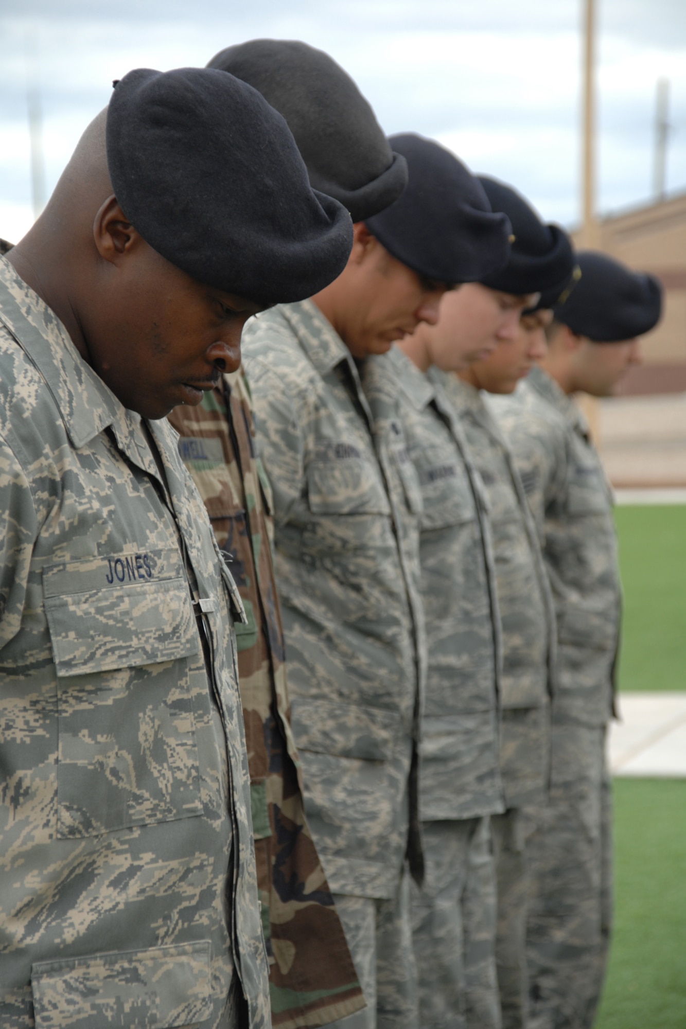 Members of the 49th Security Forces Squadron bow their heads during prayer during a National Police Week Remembrance ceremony May 16 at Holloman Air Force Base, N.M. The yearly ceremony is an event held to honor fallen law enforcement personnel, both civilian and military. (U.S. Air Force photo/Airman 1st Class Jamal D. Sutter)