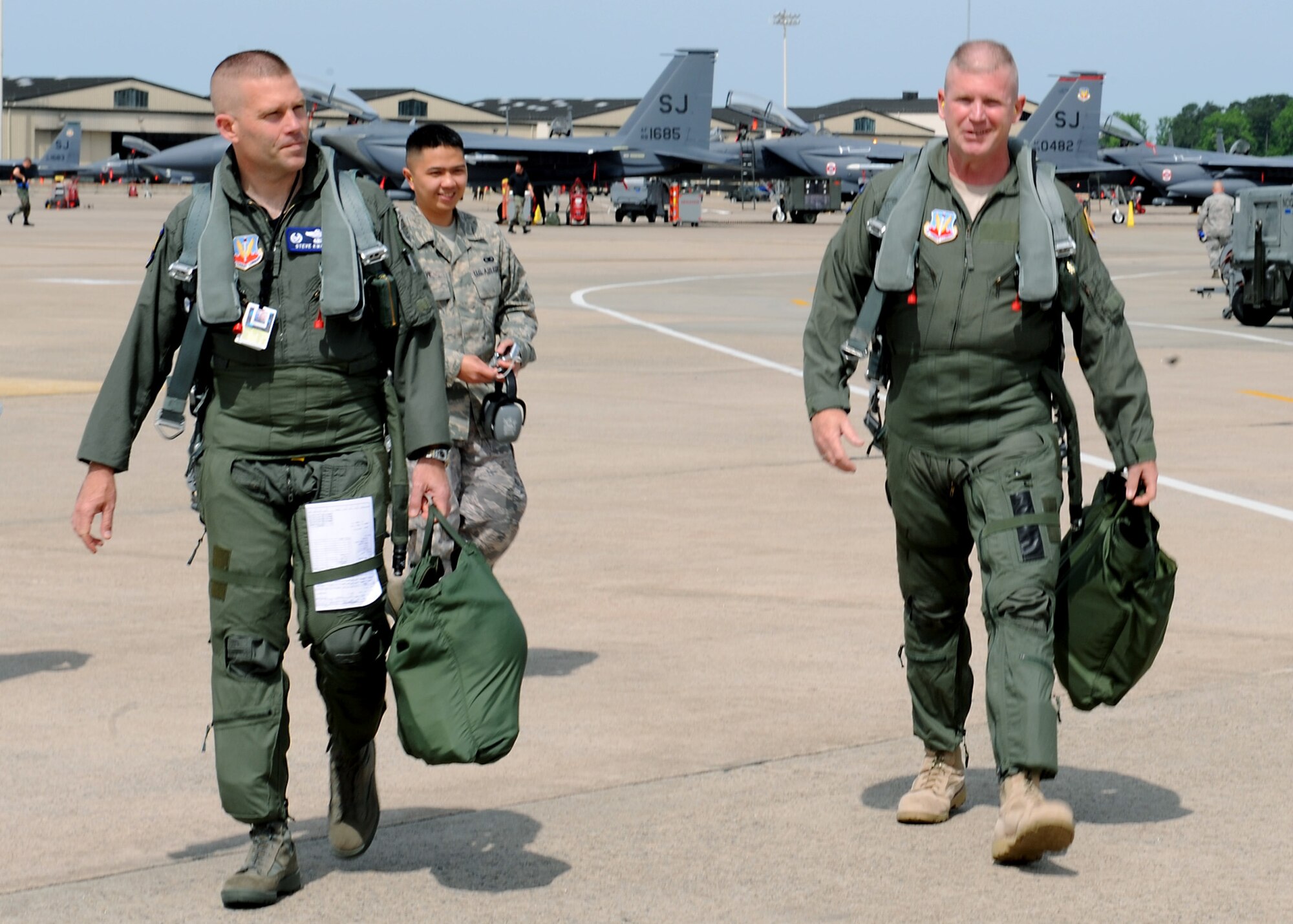 Senior Airman Carlo Clave, 4th Fighter Wing, escorts Colonel Steven Kwast, 4th Fighter Wing Commander, and Chief Master Sergeant Layton Clark, 4th Fighter Wing Command Chief, to an F-15 E Strike Eagle at Seymour Johnson AFB, North Carolina, May 14, 2008.  Chief Clark received the incentive flight as part of his farewell before he departs Seymour Johnson AFB for his new assignment at Langley AFB, Virginia.  
(US Air Force photo Airman First Class Salma Nebot)(Released)