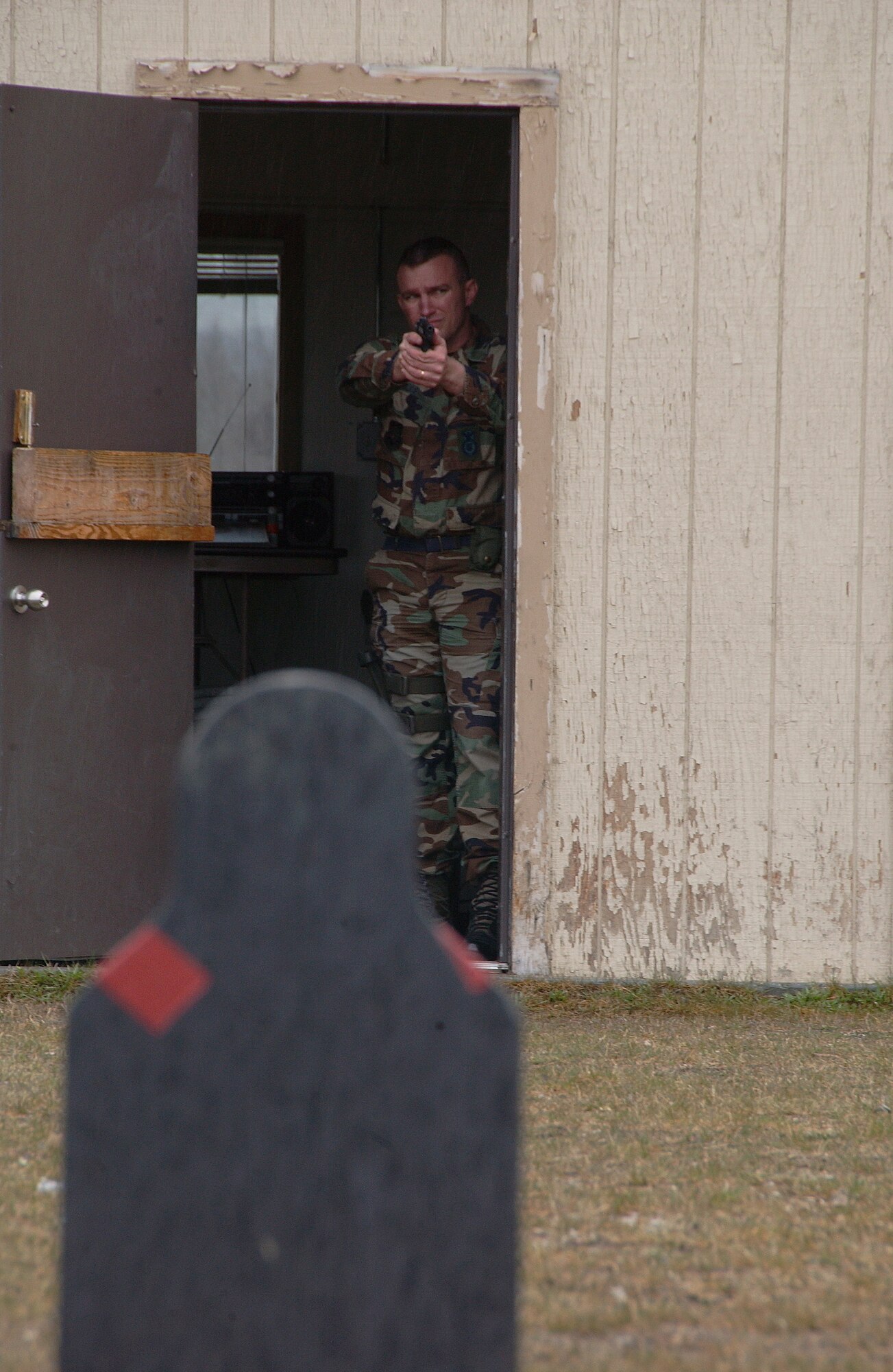 Tech. Sgt. Jason Rode aims down range at silhouette targets during a Police week pistol competition May 13, 2008, at Eielson Air Force Base, Alaska. The 354th Security Forces Squadron hosted events all throughout the week for families and community involvement. Police week is designed to honor those who are serving and served in law enforcement. Sergeant Rode is assigned to the 213th Space Warning Squdron at Clear Air Station, Alaska. (U.S. Air Force Photo/Airman 1st Class Jonathan Snyder)