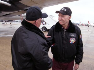 ANDREWS AIR FORCE BASE, Md. -- Retired Col. Gail Halvorsen, shakes hands with a fellow member of the Berlin Airlift Historical Foundation at the Joint Service Open House here May 18. Colonel Halvorsen earned the nickname the "Berlin Candy Bomber" for dropping more than 20 tons of candy to local children in Berlin, Germany, between 1948 and 1949.  The BAHF showcased the C-54E transport aircraft dubbed, "The Spirit of Freedom." The foundation is dedicated to preserving the memory and legacy of a key humanitarian and aviation historical event, The Berlin Airlift. (U.S. Air Force photo/Staff Sgt. Amaani Lyle)