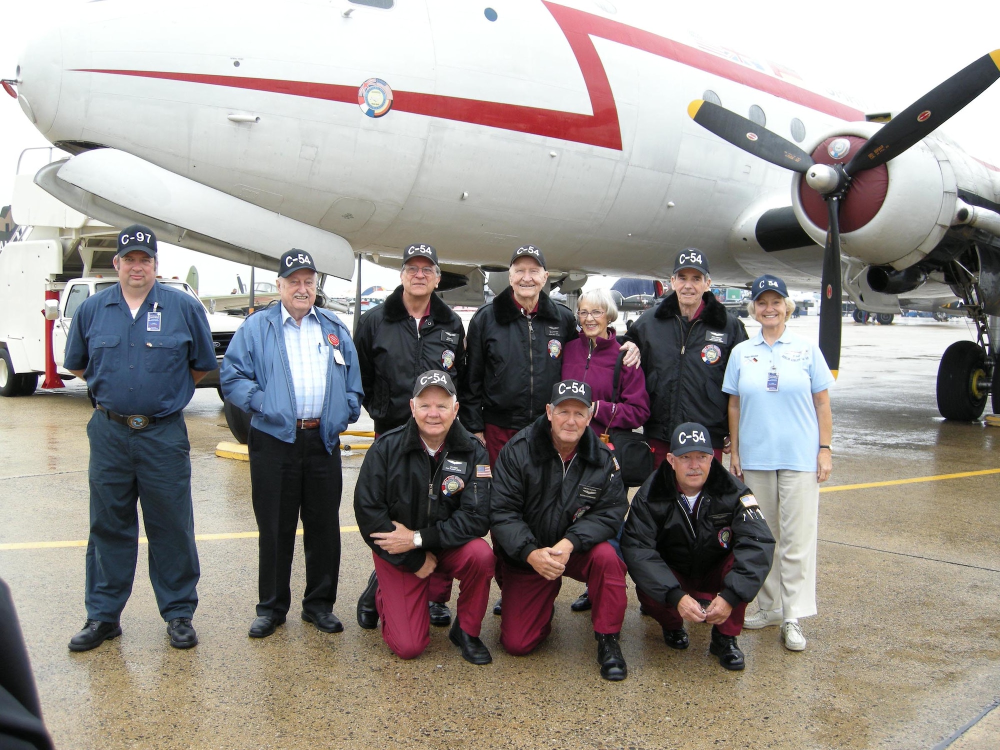 ANDREWS AIR FORCE BASE, Md. -- Members of the the Berlin Airlift Historical Foundation pose with Retired Col. Gail Halvorsen (center) and his wife Lorraine (third from right) at the Joint Service Open House here May 18. Colonel Halvorsen earned the nickname the "Candy Bomber" for dropping more than 20 tons of candy to local children in Berlin, Germany, between 1948 and 1949.  The BAHF stands before the C-54E transport aircraft dubbed, "The Spirit of Freedom." The foundation is dedicated to preserving the memory and legacy of a key humanitarian and aviation historical event, The Berlin Airlift. (U.S. Air Force photo/Staff Sgt. Amaani Lyle)