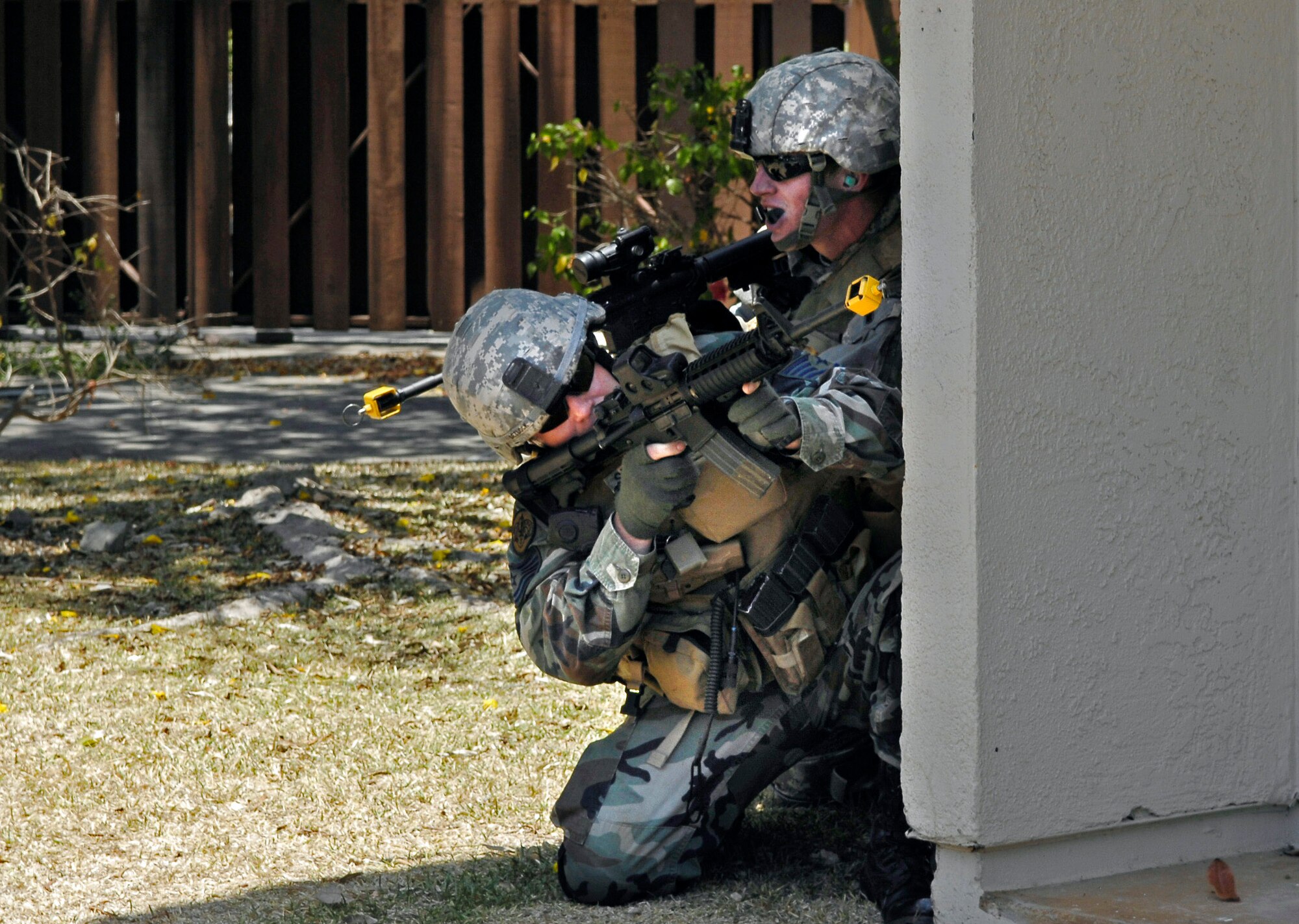 Tech. Sgt. Richard Setlock (left) and Airman 1st Class Daniel Meyer, joint terminal attack controllers, execute their attack plan during close-quarters battle training May 7 at Hickam Air Force Base, Hawaii.  The JTACs were using an old housing area on Hickam AFB to conduct realistic training in an urban environment.  Both Airmen are assigned to the 25th Air Support Operations Squadron at Wheeler Army Air Field, Hawaii. (U.S. Air Force photo/Tech. Sgt. Chris Vadnais)