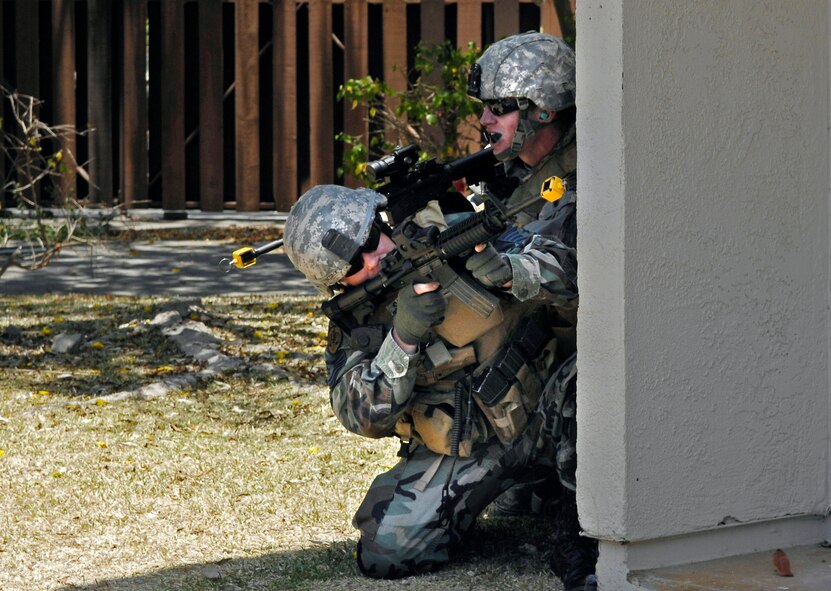 Tech. Sgt. Richard Setlock (left) and Airman 1st Class Daniel Meyer, joint terminal attack controllers, execute their attack plan during close-quarters battle training May 7 at Hickam Air Force Base, Hawaii.  The JTACs were using an old housing area on Hickam AFB to conduct realistic training in an urban environment.  Both Airmen are assigned to the 25th Air Support Operations Squadron at Wheeler Army Air Field, Hawaii. (U.S. Air Force photo/Tech. Sgt. Chris Vadnais)