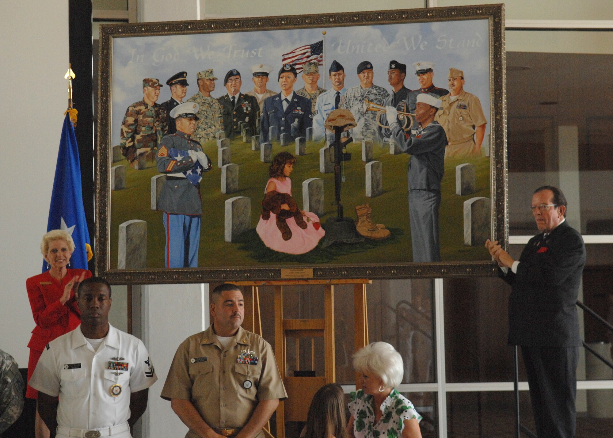 DYESS AIR FORCE BASE, Texas-- The Painting called "Our Heroes", created by Mike Lanier, is unveiled to honor the members of the United States military at the Abilene Civic Center, May 20. The large painting, 5 feet by 8 feet was commissioned by Jack and Sandie North, owners of North's Funeral Home of Abilene, Texas. (U.S. Air Force by Airman 1st Class Stephen Reyes)