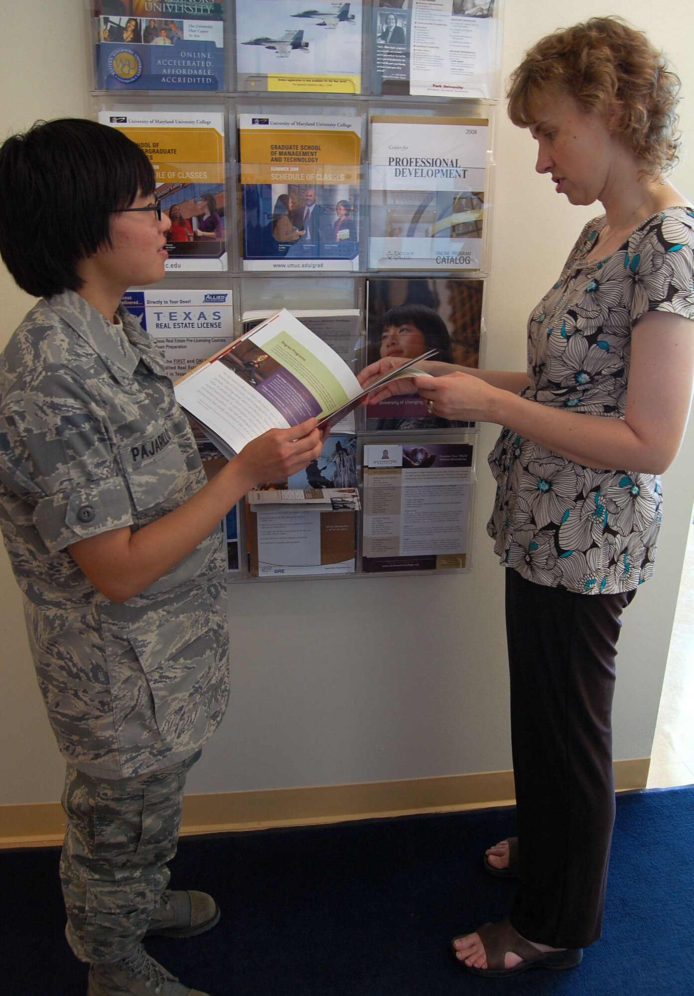 LAUGHLIN AIR FORCE BASE, Texas – Christine Engel, 47th Force Development Flight, education and training chief, explains education options to Airman Basic Xanthe Pajarillo, 47th Medical Support Squadron, at the Education Center May 20. Engel supports all base personnel including Airmen, civilians, spouses and families with all of their educational needs. “Helping people is what we like doing here,” said Engel. “It is very rewarding to know that we help to put people on the road to success.” (U.S. Air Force photo by Airman 1st Class Sara Csurilla)