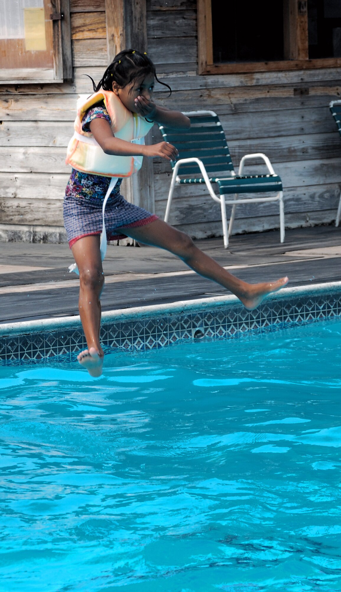 A girl from the Hogar de Guadalupe Orphanage jumps into the pool during a kids' day May 18 at Soto Cano Air Base, Honduras. About 40 volunteers from the 612th Air Base Squadron spent the day playing games and interacting with the children. (U.S. Air Force photo/Tech. Sgt. John Asselin) 
