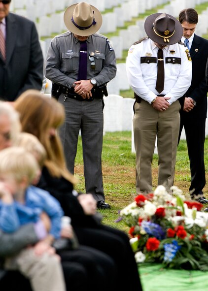 Local law enforcement officers bow their heads in honor of Air Force Office of Special Investigations Special Agent Thomas Crowell as he was buried at Arlington National Cemetery. (U.S. Air Force photo/Mike Hastings)