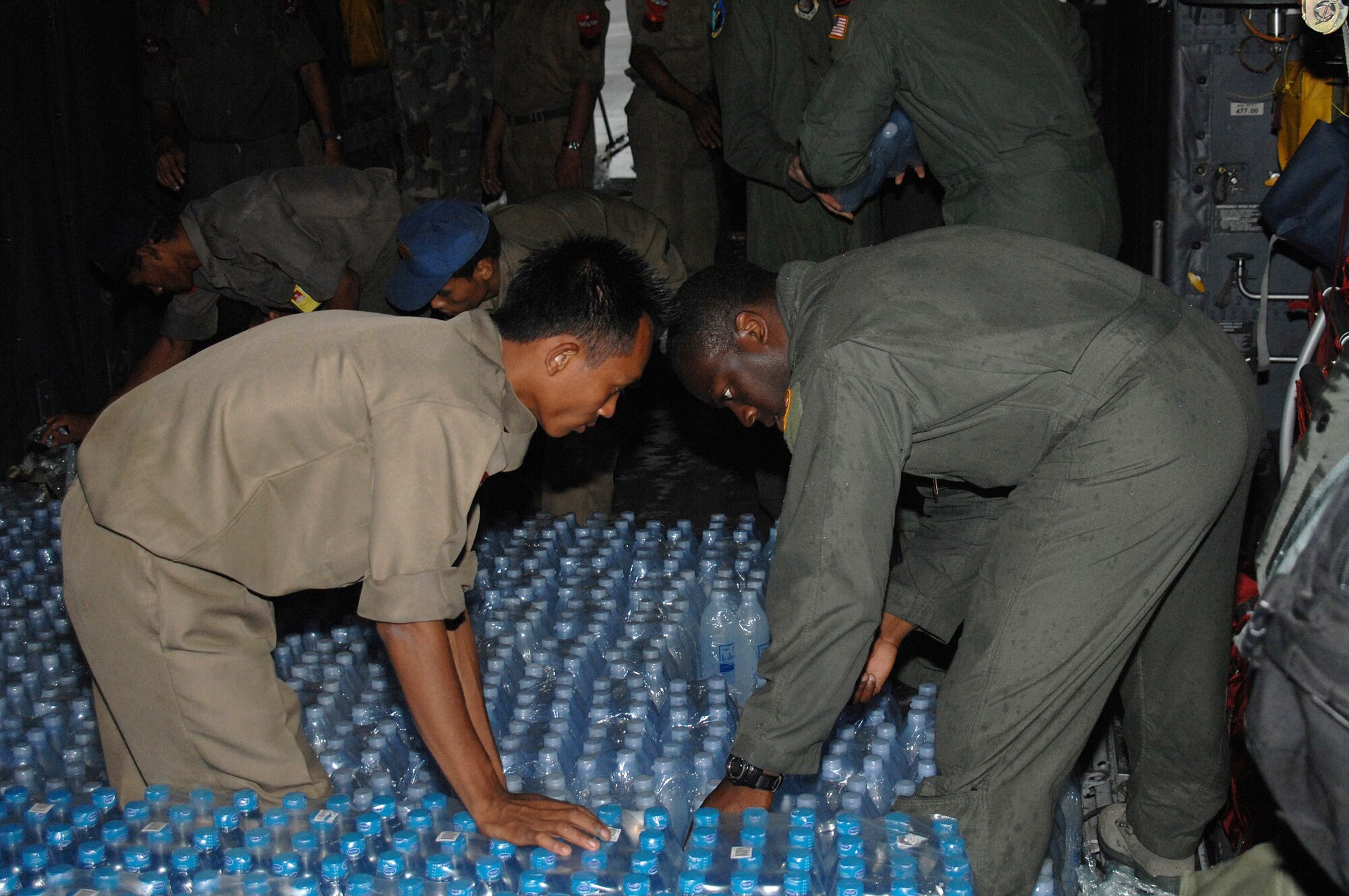 Capt. Kristopher Duckett assists with the delivery of humanitarain relief supplies delivered May 19 at the Yangon International Airport in Burma. Capt Duckett is a pilot with the 374th Airlift Wing from Yokota Air Base, Japan. The relief supplies will be delivered to the citizens of Burma who were devastated by a recent cyclone. (U.S. Air Force photo/Senior Airman Sonya Croston) 