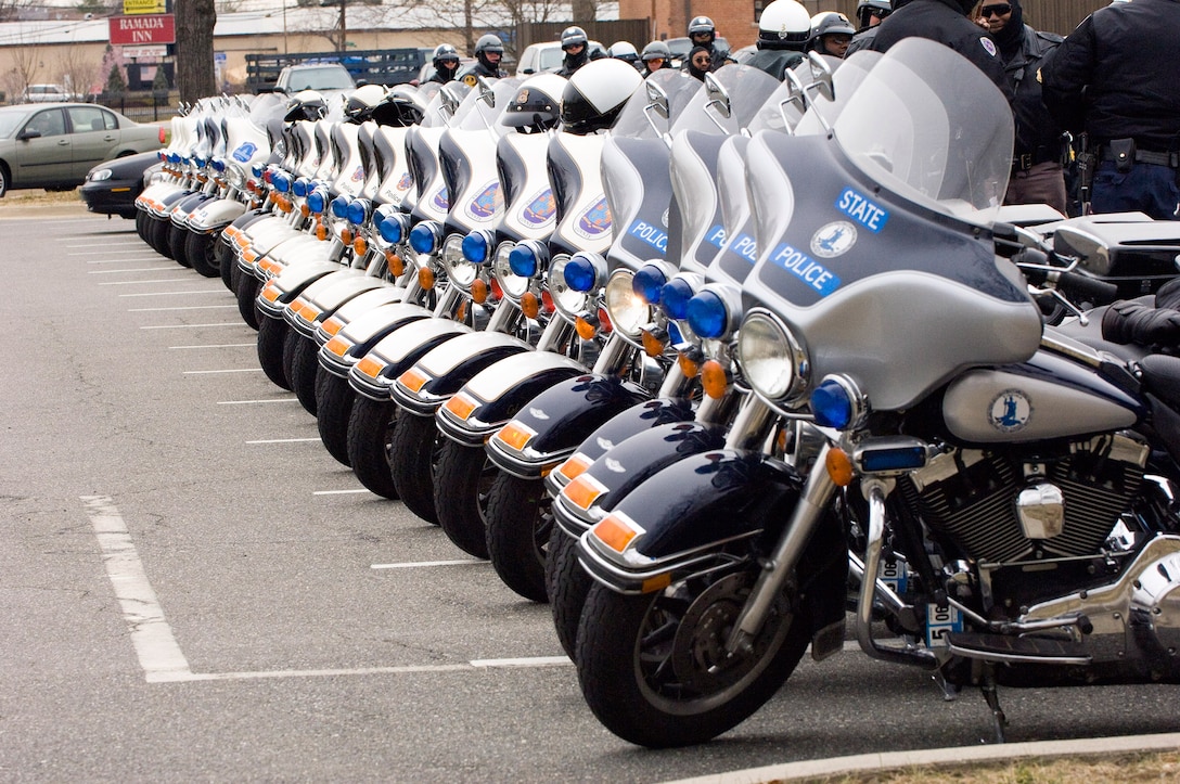 A long line of local police motorcycles await the funeral procession of Air Force Office of Special Investigations Special Agent Thomas Crowell heading to Arlington National Cemetery. (U.S. Air Force photo/Mike Hastings)