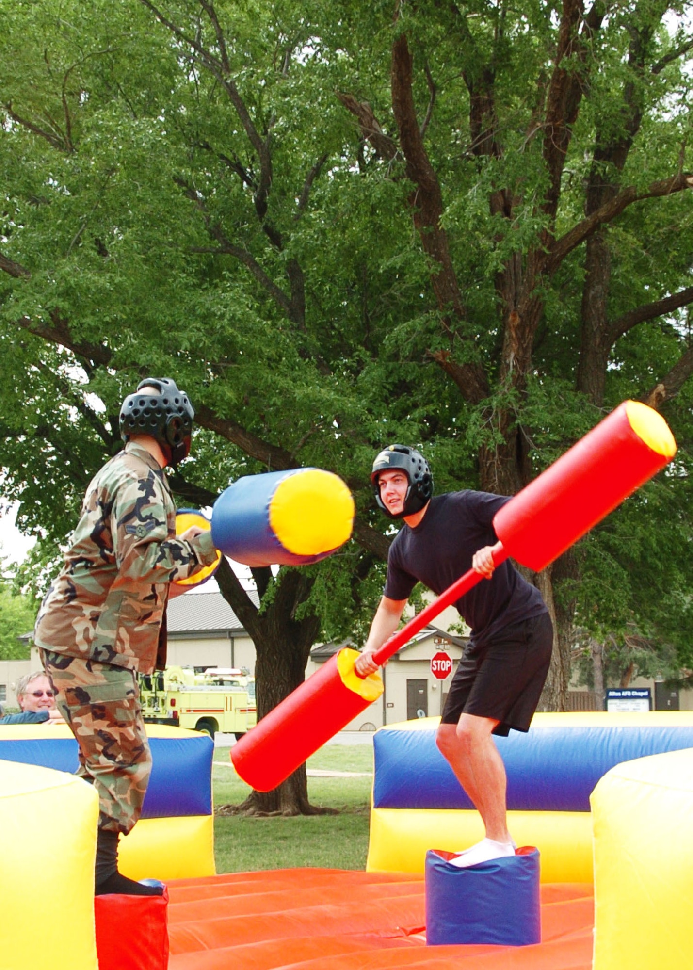 ALTUS AIR FORCE BASE, Okla. -- Two Airmen battle each other in a gladiator jousting competition during the Altus AFB Police Week "Gut Check" event in celebration of National Police Week and Safety Week at the Base Parade Grounds May 14. Other events included an obstacle course, HMMVEE pull, water obstacle, dunk booth and pie-in-the-face contest. (U.S. Air Force photo/Airman 1st Class Marianne Lane)
