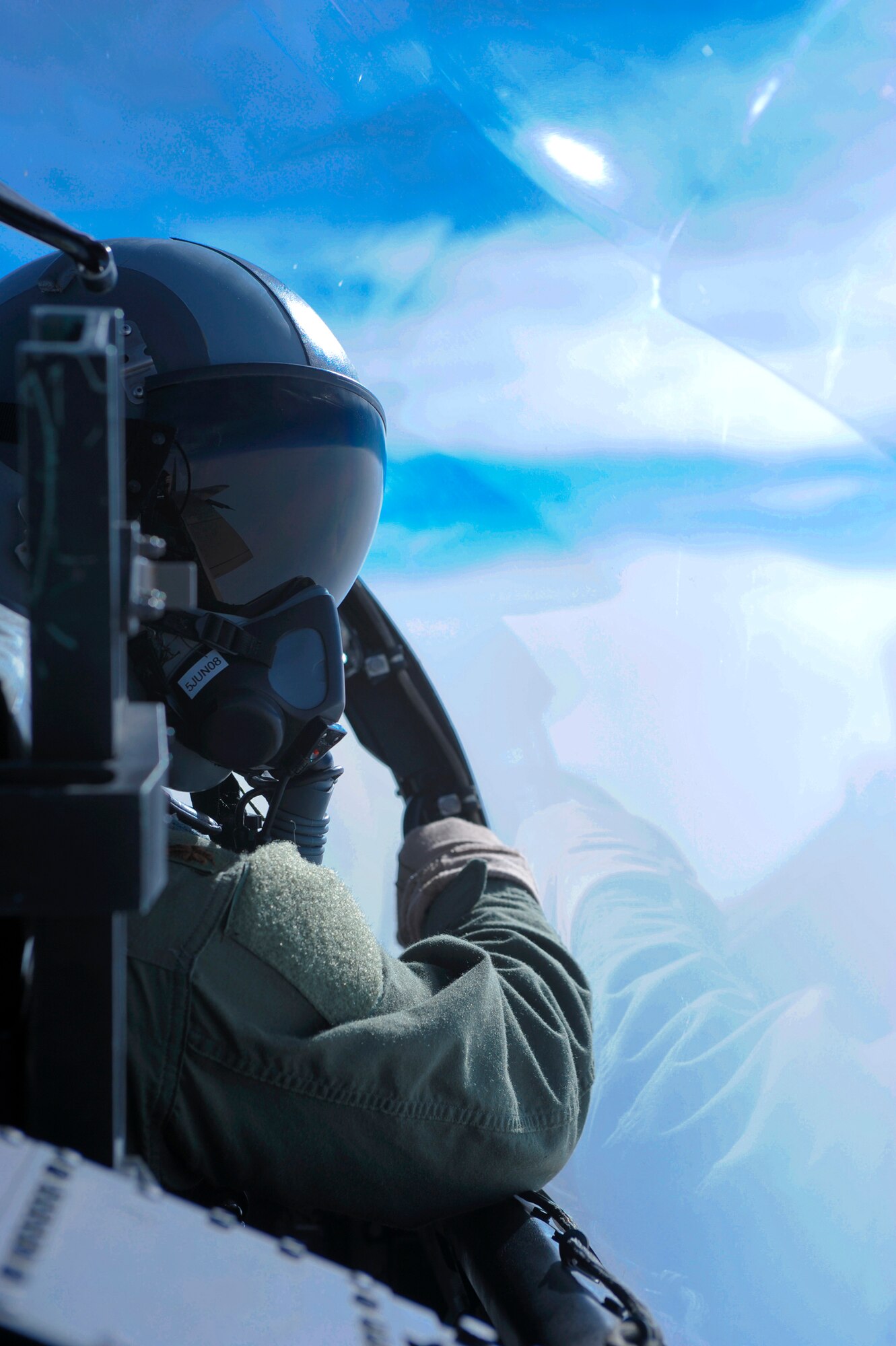 Over the Ranges of Alaska -- F-15 Eagle pilot Maj. Mark Sadler of Nellis Air Force Base, Nevada's 65th Aggressor Squadron, looks for other aircraft fighting the air war of Northern Edge 2008. NE08 is a joint training exercise that provides effective, flexible and capabilities-centered joint forces ready for deployment worldwide and enables real world proficiency in detections and tracking of units at sea, in the air, and on land in response to multiple crises. Over 5,000 servicemembers and 120 aircraft are involved in the exercise that is scheduled for May 5 - 16. (Photo by Master Sgt Keith Brown)