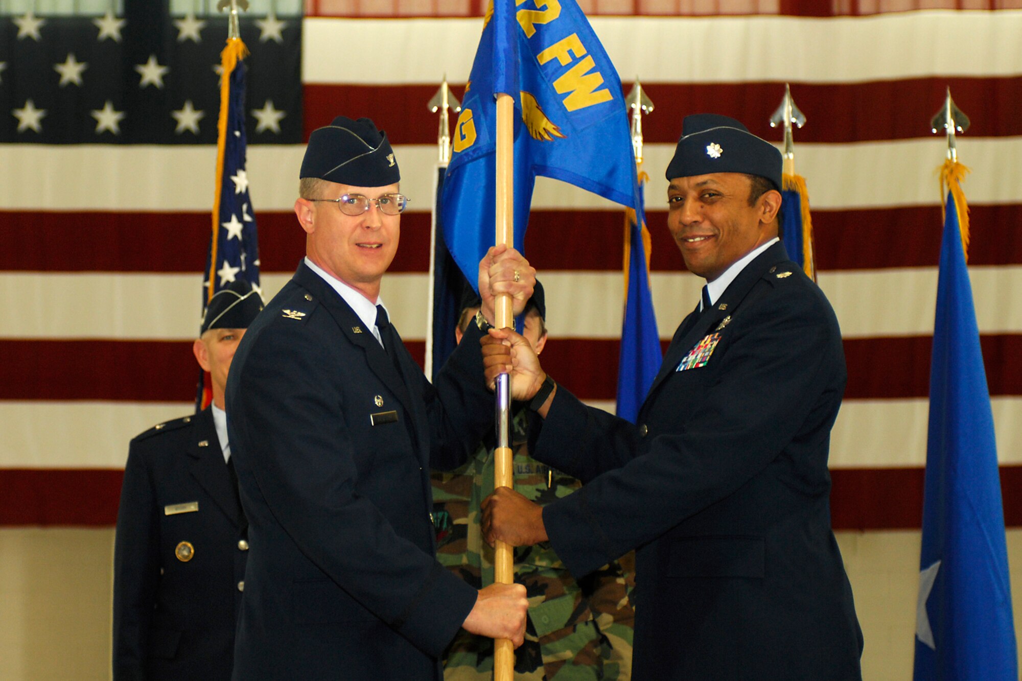 LANGLEY AIR FORCE BASE, Va. -- Col. Jay Pearsall previous 192nd Fighter Wing commander (left), hands the 192nd FW Operations Group flag to the new 192nd OG commander, Lt. Col. Bryan Turner, during a wing change of command here May 17.  (U.S. Air Force photo/Airman Gul Crockett)