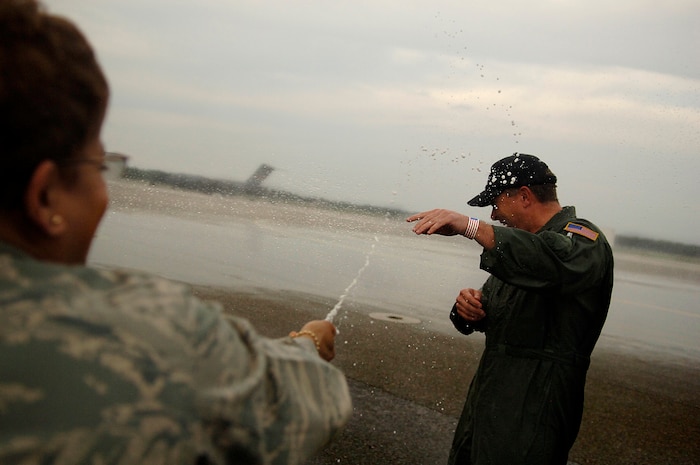 Col. Donnalee Sykes hoses down Col. John Michel after he completes his final flight on the Charleston AFB flightline May 18. Colonel Michel is leaving Charleston to become the Grand Forks AFB, N.D., wing commander. Currently he is the 437th Airlift Wing vice wing commander and Colonel Sykes is the 437th Medical Group commander. (U.S. Air Force photo/Senior Airman Nicholas Pilch)