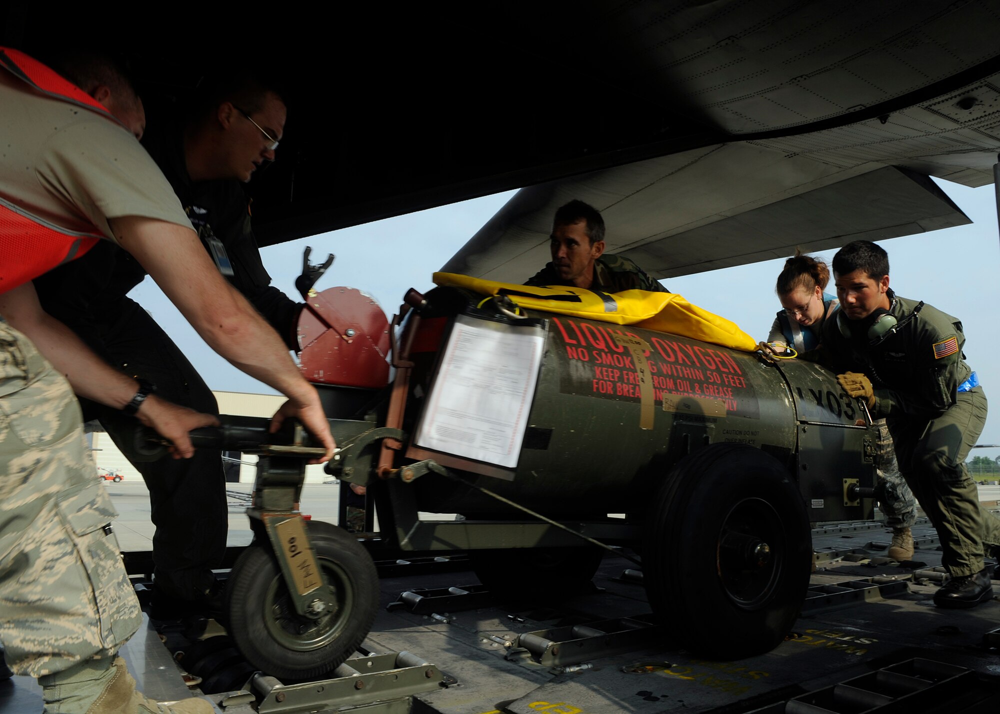 MOODY AIR FORCE BASE, Ga. -- Airmen of the 23rd Wing load a liquid oxygen tank onto a HC-130P King during a hurricane evacuation exercise here May 21. The exercise prepares Airmen for real-world humanitarian efforts.   (U.S. Air Force photo by Airman 1st Class Brittany Barker)