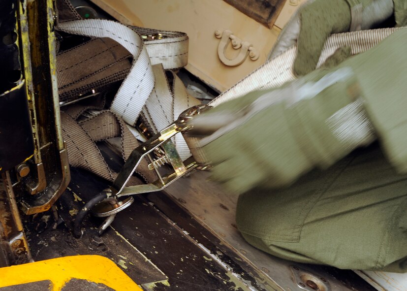 MOODY AIR FORCE BASE, Ga. -- Senior Airman Sean Helm, 71st Rescue Squadron loadmaster, secures a pallet to a HC-130P King during a humanitarian relief deployment exercise here May 21. The Global Response Force exercise prepared Airmen for real-world humanitarian efforts in the aftermath of a natural disaster. (U.S. Air Force photo by Airman 1st Class Brittany Barker) 
