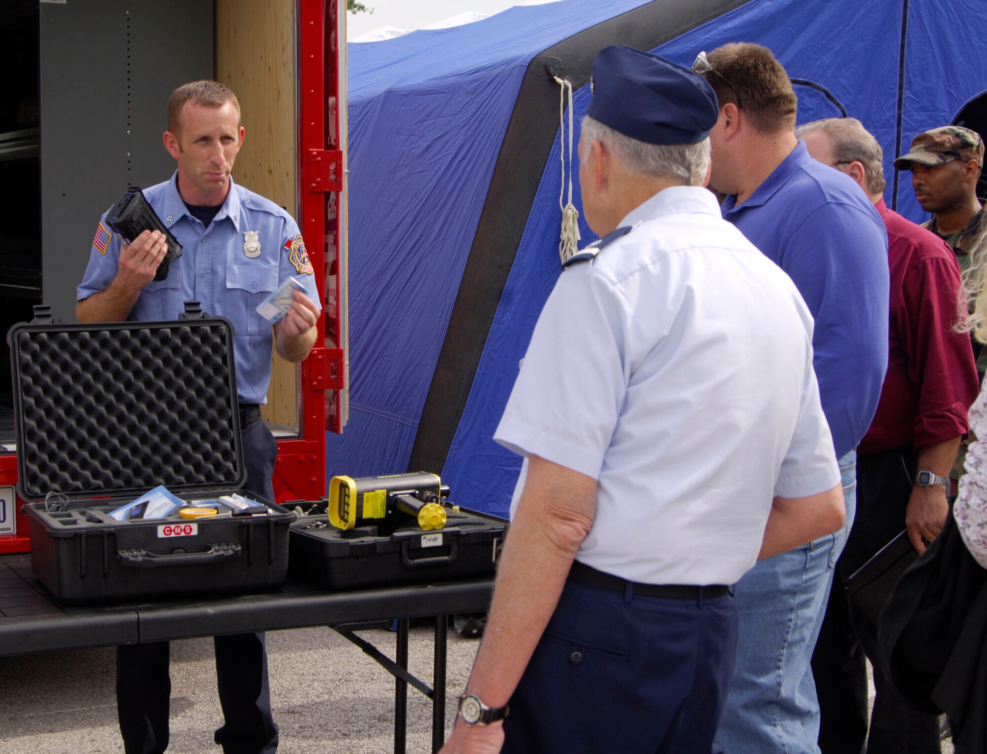 SCOTT AIR FORCE BASE, Ill. -- Michael Moore, 375th Civil Engineer Squadron firefighter, explains to members of the surrounding communities how the hazardous chemical detectors work that are used by the department at a demonstration put on by the 375th CES on May 14. The chemical detectors test areas for any type of chemicals and find out exactly how much of any one chemical is in the area. (U.S. Air Force photo/Airman 1st Class Wesley Farnsworth)