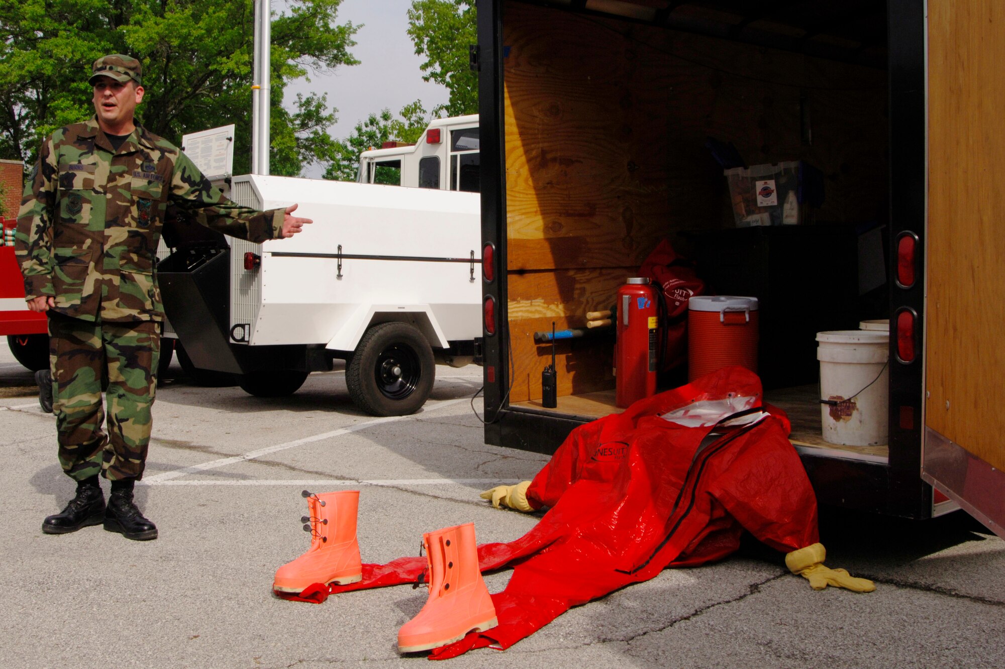 SCOTT AIR FORCE BASE, Ill. -- Staff Sgt. Paul Burns, 375th Civil Engineer Squadron firefighter, shows off the hazmat emergency response trailer used by the fire department during a demonstration for the surrounding communities May 14. The hazmat trailer carries most of the supplies needed by the department, such as their suits and gloves, when dispatched to a scene. (U.S. Air Force photo/Airman 1st Class Wesley Farnsworth)