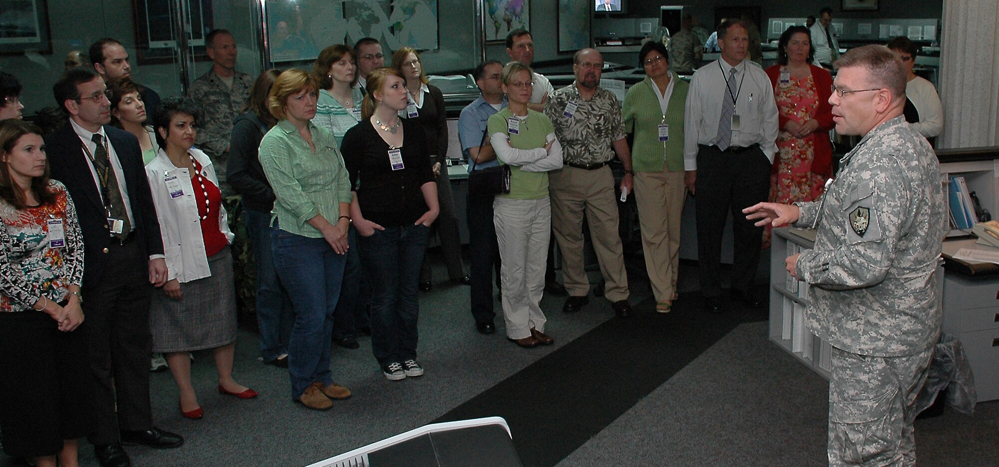 SCOTT AIR FORCE BASE, Ill. -- Col. Robert Johnson, U.S. Transportation Command, explains the operation of the USTRANSCOM Deployment and Distribution Operations Center to husbands and wives of command workers during the annual USTRANSCOM Spouse's Day activities May 15. Family members watched the command briefing, toured the facilities and attended a picnic lunch during the five-hour event, which gave husbands and wives of USTRANSCOM workers a better understanding of what their loved ones do at work. (U.S. Air Force photo/Bob Fehringer)