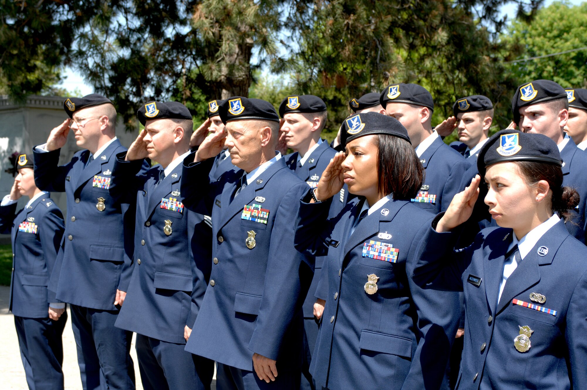 SEDALIA, Mo., - Members of the 509th Security Forces Squadron render a salute as the flag is lowered to half staff May 17 during the 20th Annual Whiteman Memorial Wreath Laying Ceremony in Sedalia's Memorial Park Cemetery. The ceremony honored 2nd Lt. George A. Whiteman, a Sedalia native and the first American air casualty of World War II. Lieutenant Whiteman?s P-40 fighter, "Lucky Me," was shot down as he took off during the Japanese attack on Pearl Harbor Dec. 7, 1941. (U.S. Air Force/1st Lt. Matthew Miller)