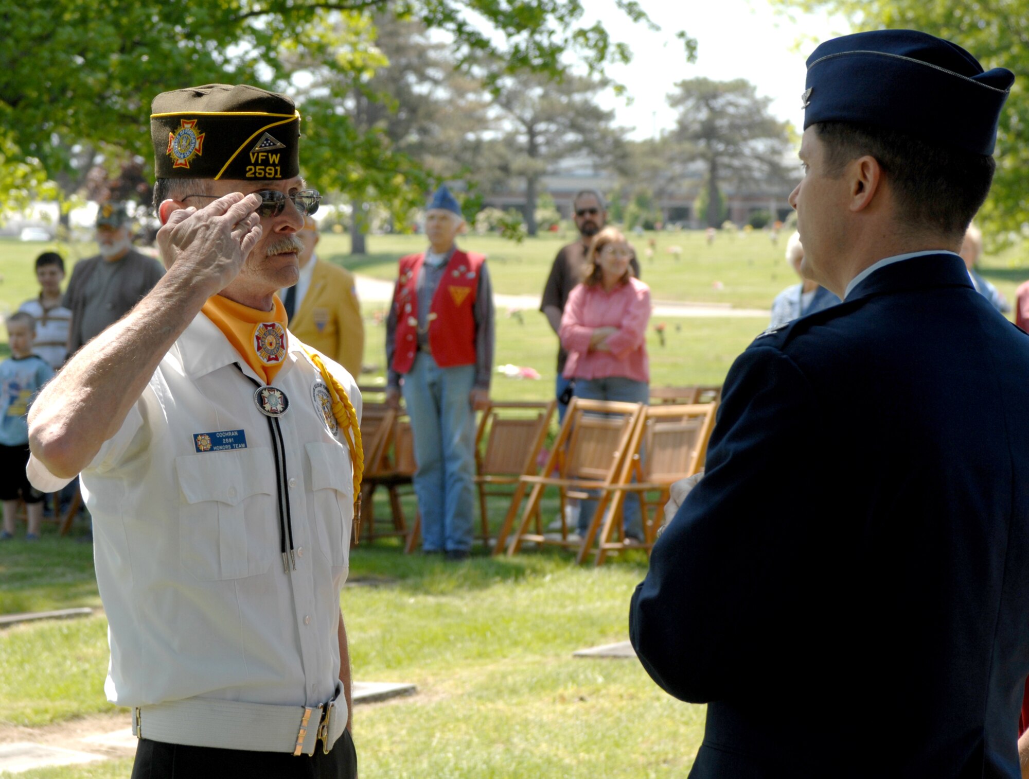 SEDALIA, Mo., - Joe Cochran, VFW Post 2591, delivers a salute after handing a folded American flag to Col. John W. Robinson Jr., 509th Bomb Wing vice commander. The folding of the flag was part of the 20th Annual Whiteman Memorial Wreath Laying Ceremony in Sedalia's Memorial Park Cemetery. The ceremony honored 2nd Lt. George A. Whiteman, a Sedalia native and the first American air casualty of World War II. Lieutenant Whiteman?s P-40 fighter, "Lucky Me," was shot down as he took off during the Japanese attack on Pearl Harbor Dec. 7, 1941. (U.S. Air Force/1st Lt. Matthew Miller)