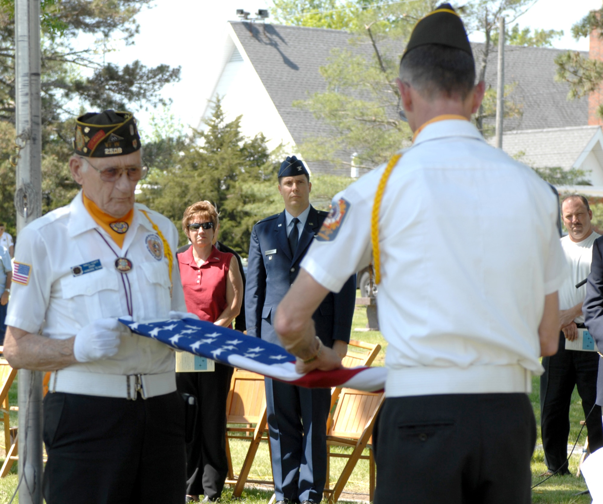 SEDALIA, Mo., - Al Hall, left, and Joe Cochran, right, both with VFW Post 2591, fold the flag during the 20th Annual Whiteman Memorial Wreath Laying Ceremony in Sedalia's Memorial Park Cemetery. (U.S. Air Force/1st Lt. Matthew Miller)
