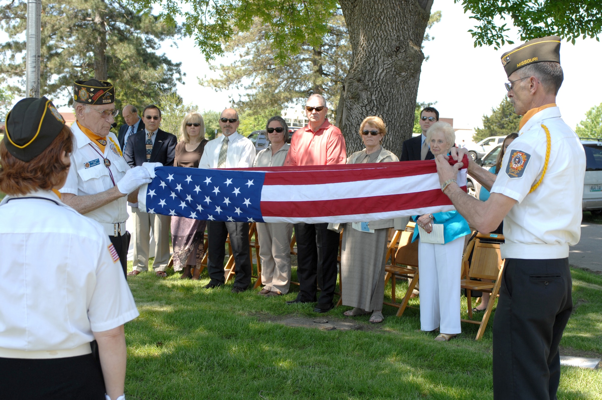 SEDALIA, Mo., - Al Hall, left, and Joe Cochran, right, both with VFW Post 2591, fold the flag during the 20th Annual Whiteman Memorial Wreath Laying Ceremony in Sedalia's Memorial Park Cemetery. (U.S. Air Force/1st Lt. Matthew Miller)