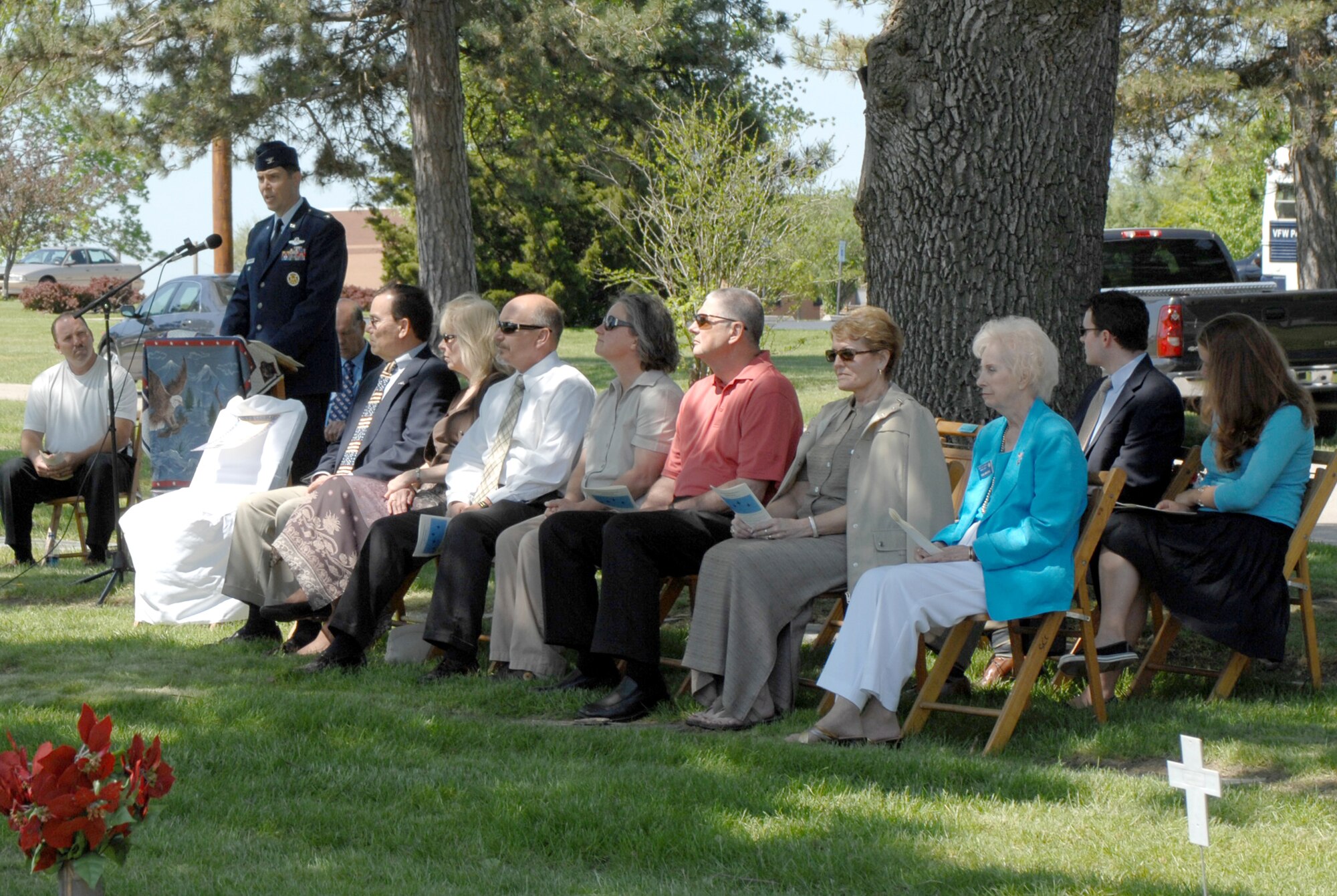 SEDALIA, Mo., - Relatives of the George A. Whiteman and Eva Myers, far right, representative from the Sedalia Chamber of Commerce's Military Affairs Committee, listen to keynote speaker Col. John W. Robinson Jr., 509th Bomb Wing vice commander, during the 20th Annual Whiteman Memorial Wreath Laying Ceremony in Sedalia's Memorial Park Cemetery. (U.S. Air Force/1st Lt. Matthew Miller)