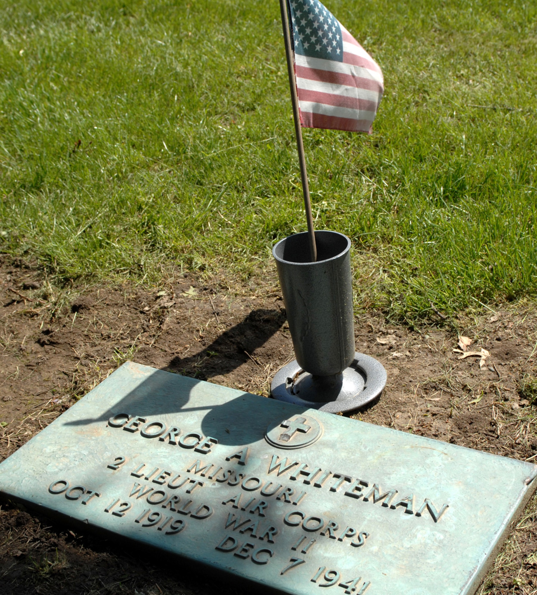 SEDALIA, Mo., - An urn holding a small American flag marks the head stone of 2nd Lt. George A. Whiteman at Sedalia's Memorial Park Cemetery. Nearly 50 Sedalia residents, Whiteman relatives and base members paid homage to Lieutenant Whiteman and the men and women currently serving in the armed forces May 17 during the 20th Annual Whiteman Memorial Wreath Laying Ceremony. The ceremony coincided with Armed Forces Day. (U.S. Air Force/1st Lt. Matthew Miller)