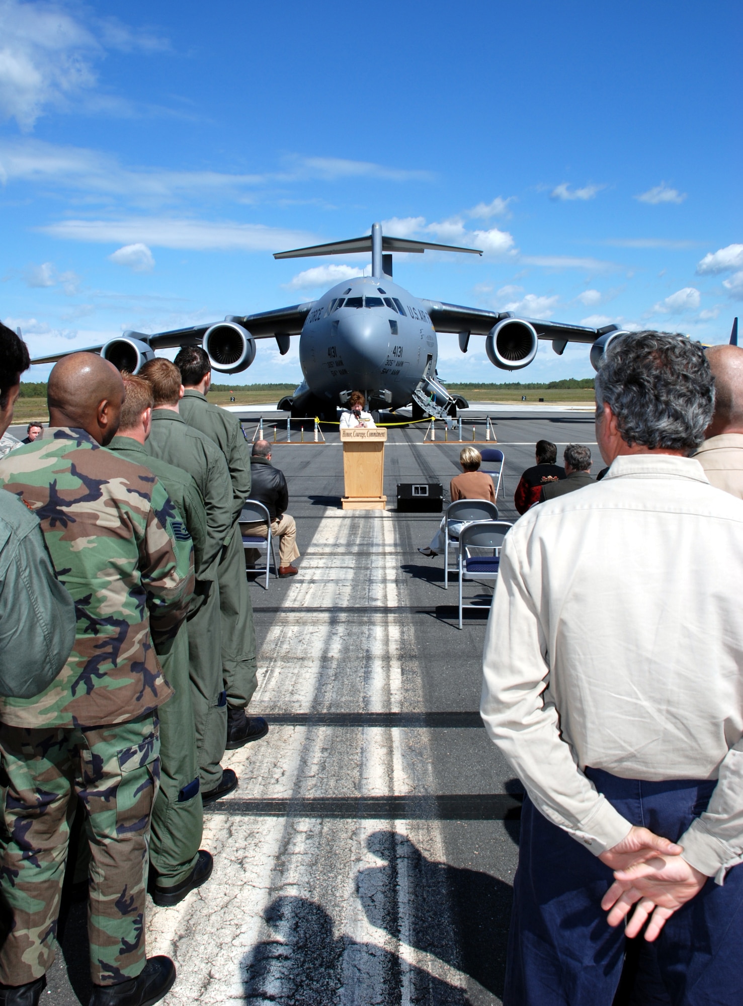 Pattie Odoardo, Lakehurst public affairs officer, narrates at the C-17 Northeast Landing Zone ceremony at Lakehurst May 19. Col. Balan Ayyar, 305th Air Mobility Wing commander, was the first to land an aircraft on the area; a ribbon cutting followed. The new landing zone allows aircrew training for contingency operations to support East Coast C-17 and C-130 units, the U.S. Air Force Expeditionary Center, and the U.S. Air Force Weapons Instructor Course Flight Operations. It also provides aircrews with realistic training in conducting operations in an airfield environment similar to that at forward operating locations. (U.S. Air Force photo/Capt. Tony Duggan)