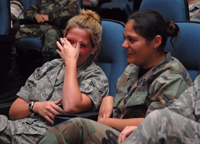 Airmen 1st Class Jessica Davis and Nicole Fabiani enjoy Bernie McGrenahan's Happy Hour Comedy show May 16 at the base theater. Airmen Davis and Fabiani are from the 437th Logistics Readiness Squadron. (U.S. Air Force photo/Senior Airman Sam Hymas)