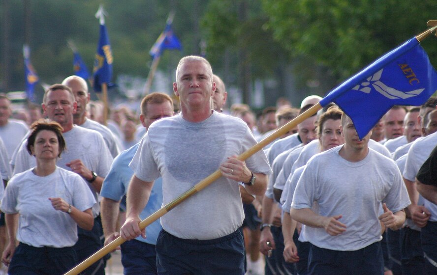 Chief Master Sgt. Brooke McLean carries the Air Education and Training Command guidon as he and hundreds of command chief master sergeants, career field managers, professional military education commandants and other key senior enlisted leaders jog down the homestretch of a 2.2-mile formation run May 18 at Maxwell Air Force Base's Gunter Annex in Alabama. The formation run officially kicked off the 2008 Senior Enlisted Leader Summit that brought together the Air Force's senior enlisted leaders in key positions throughout the Air Force to discuss current and future Air Force topics with their peers and senior Air Force officers. Chief McLean is the Little Rock Air Force Base command chief. (U.S. Air Force photo/Staff Sgt. Jason Lake) 

