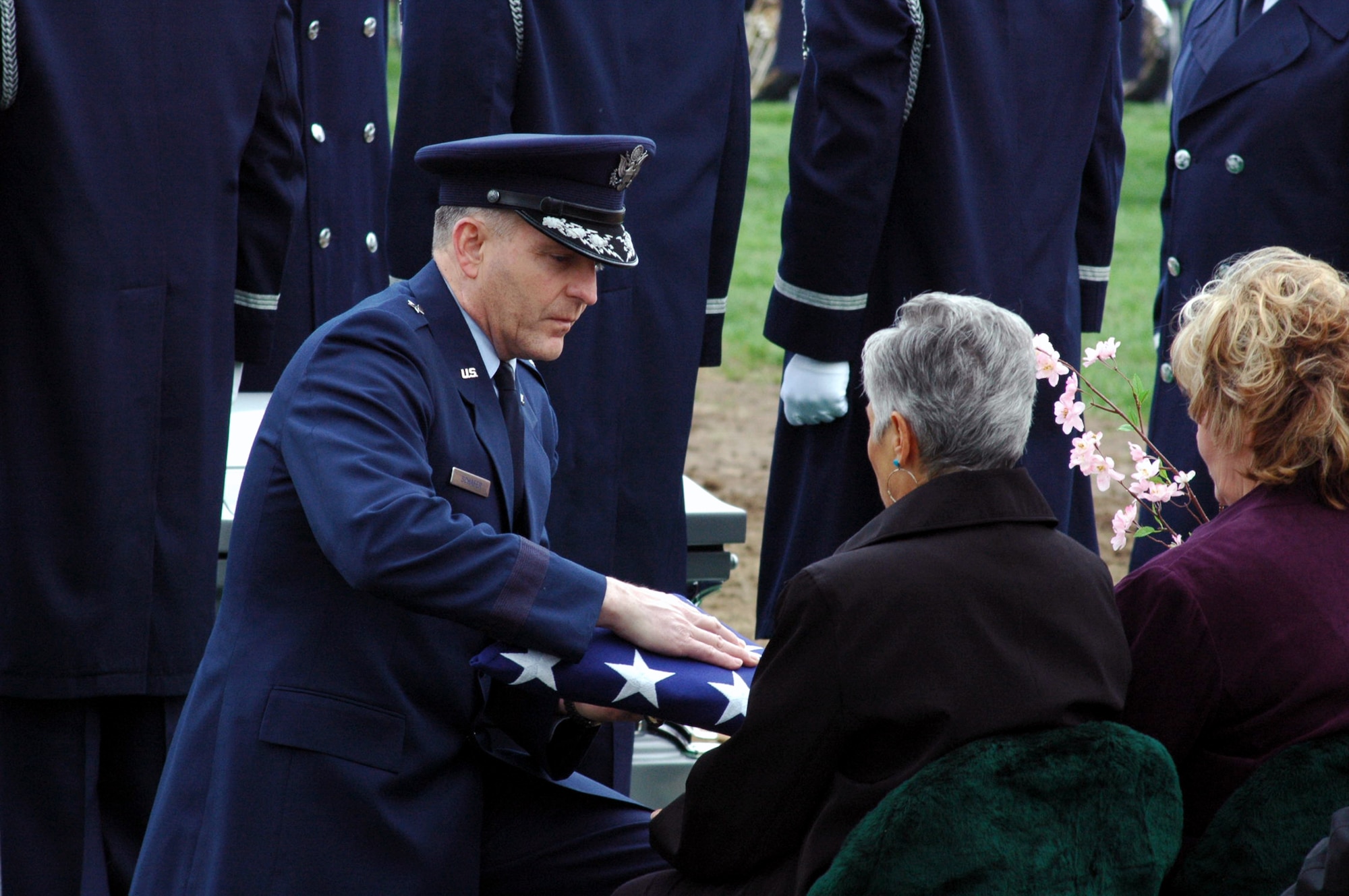 Brig. Gen. Paul Schafer, from the Office of the Secretary of Defense, presents the American flag to Mrs. Lana Taylor, oldest daughter of Maj. Robert F. Woods, during the funeral for Major Woods at Arlington National Cemetery, Va., April 9, 2008.  Major Woods was buried at Arlington nearly 40 years after he disappeared.  On Nov. 30, 2007, the Department of Defense announced they had positively identified Major Woods after a recovering remains in Vietnam.  (U.S. Air Force Photo/Tech. Sgt. Scott T. Sturkol)