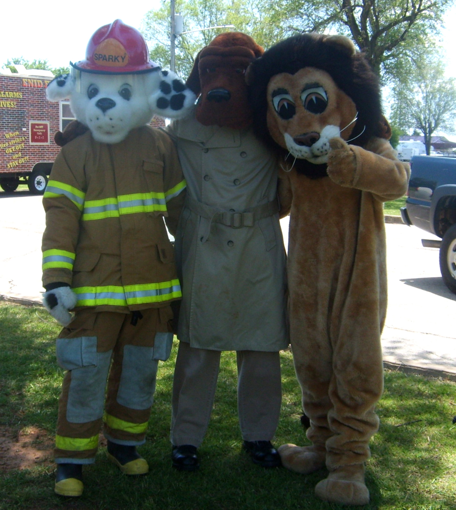 Mascots Sparky, McGruff the Crime Dog and the DARE (Drug Abuse Resistance Education) Lion celebrate national police week with children attending "Cops 4 Kids" at the base park May 16. (Courtesy photo)