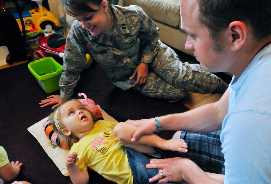 Capt. Kerri Rochman watches her 3 1/2 year-old daughter Elise May 19 as her husband, Tim, performs their daily flexibility exercises. Elise was diagnosed more than two years ago with Tays-Sachs disease, an inherited incurable disease of the central nervous system.  Captain Rochman is the 375th Mission Support Squadron chief of career development at Scott Air Force Base, Ill.  (U.S. Air Force photo/Master Sgt. Maurice Hessel)