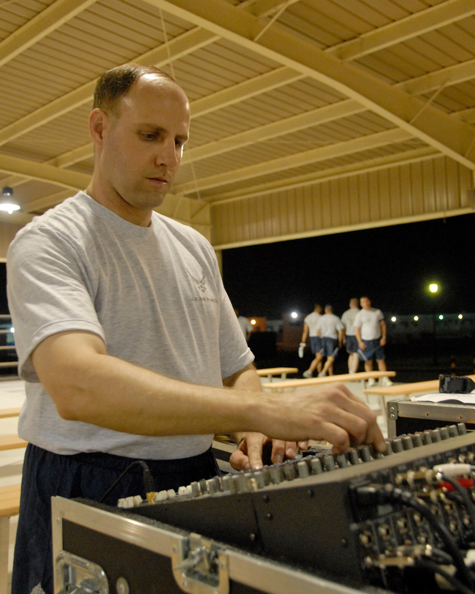 SOUTHWEST ASIA -- Staff Sgt. Clive James, an audio technician with the U.S. Air Force Central Command Band called Falcon, adjusts the levels coming out of the speakers for optimal sound quality for the audience of U.S. and coalition forces who turned out for the May 15, 2008 performance at an air base in the Persian Gulf Region.  The Falcon Band recently kicked off a 60-day tour throughout Southwest Asia and the Horn of Africa to positively promote troop morale, diplomacy and outreach to host nation communities. (U.S. Air Force photo/Tech. Sgt. Michael O'Connor)