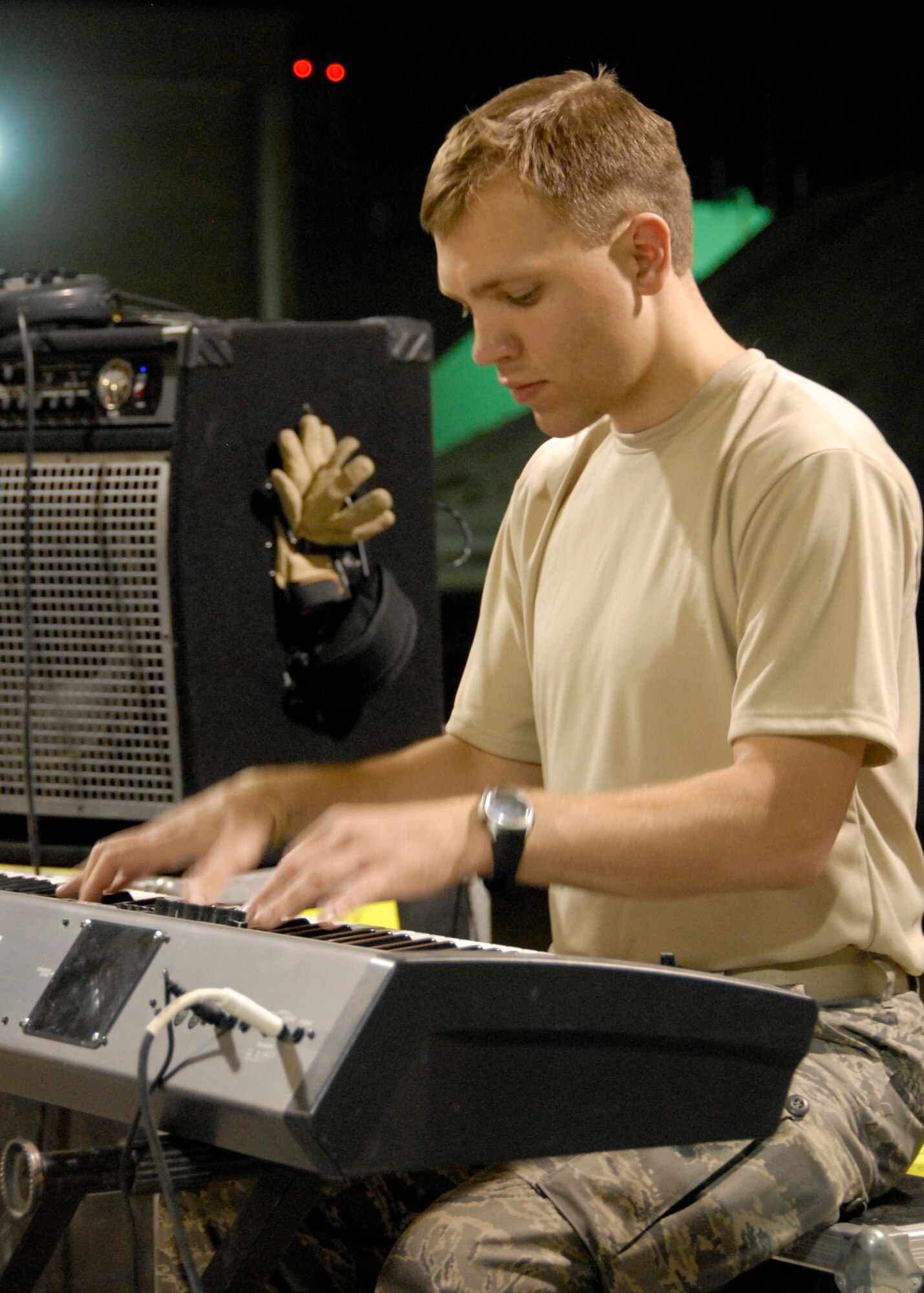 SOUTHWEST ASIA -- Airman 1st Class Michael Srstka, a pianist with the U.S. Air Force Central Command Band called Falcon gets into the mood on his electric piano in front of audience of U.S. and coalition forces during a May 15, 2008 performance at an air base in the Persian Gulf Region. The Falcon Band recently kicked off a 60-day tour throughout Southwest Asia and the Horn of Africa to positively promote troop morale, diplomacy and outreach to host nation communities. (U.S. Air Force photo/Tech. Sgt. Michael O'Connor)
